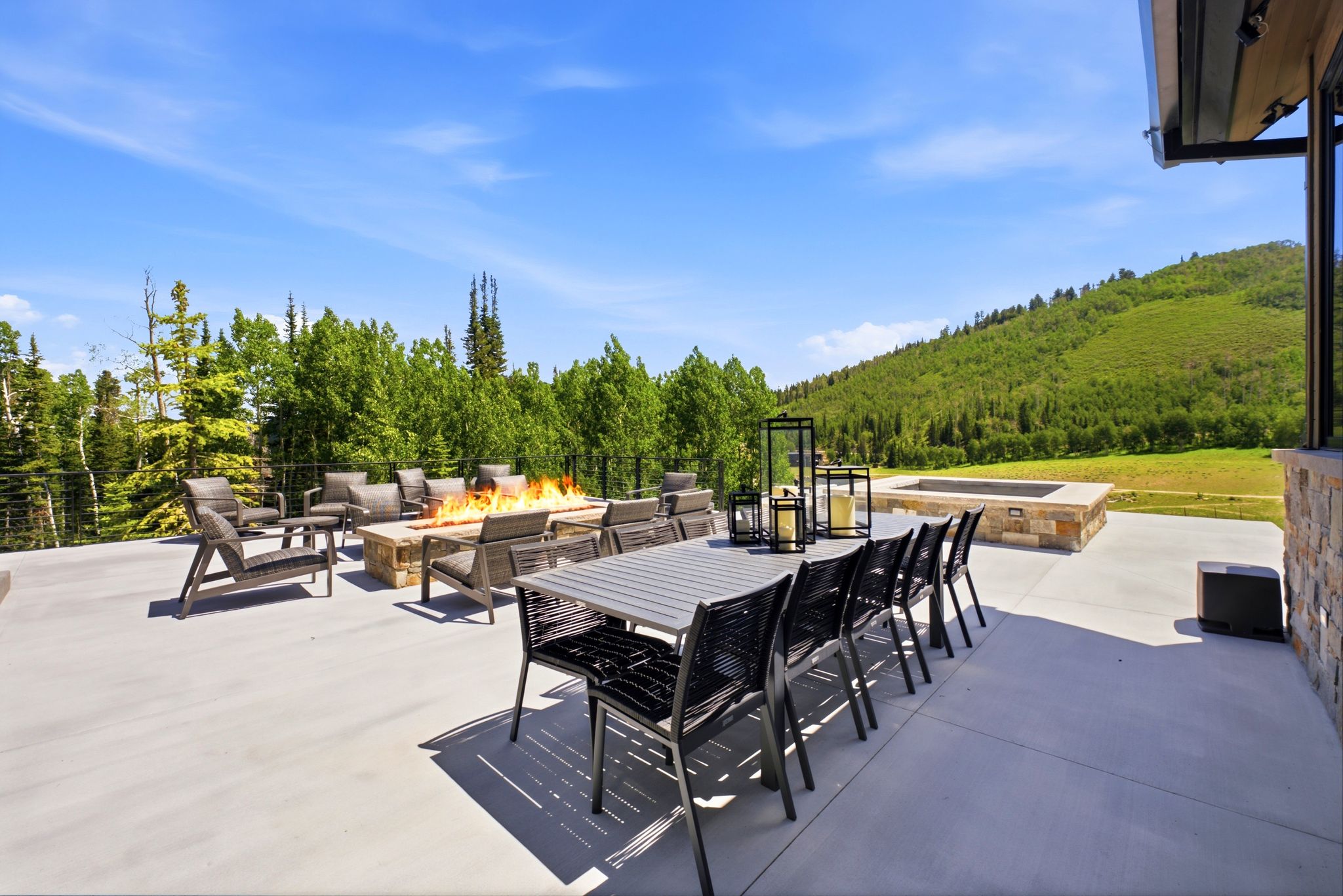 Expansive concrete patio offering multiple outdoor seating areas
