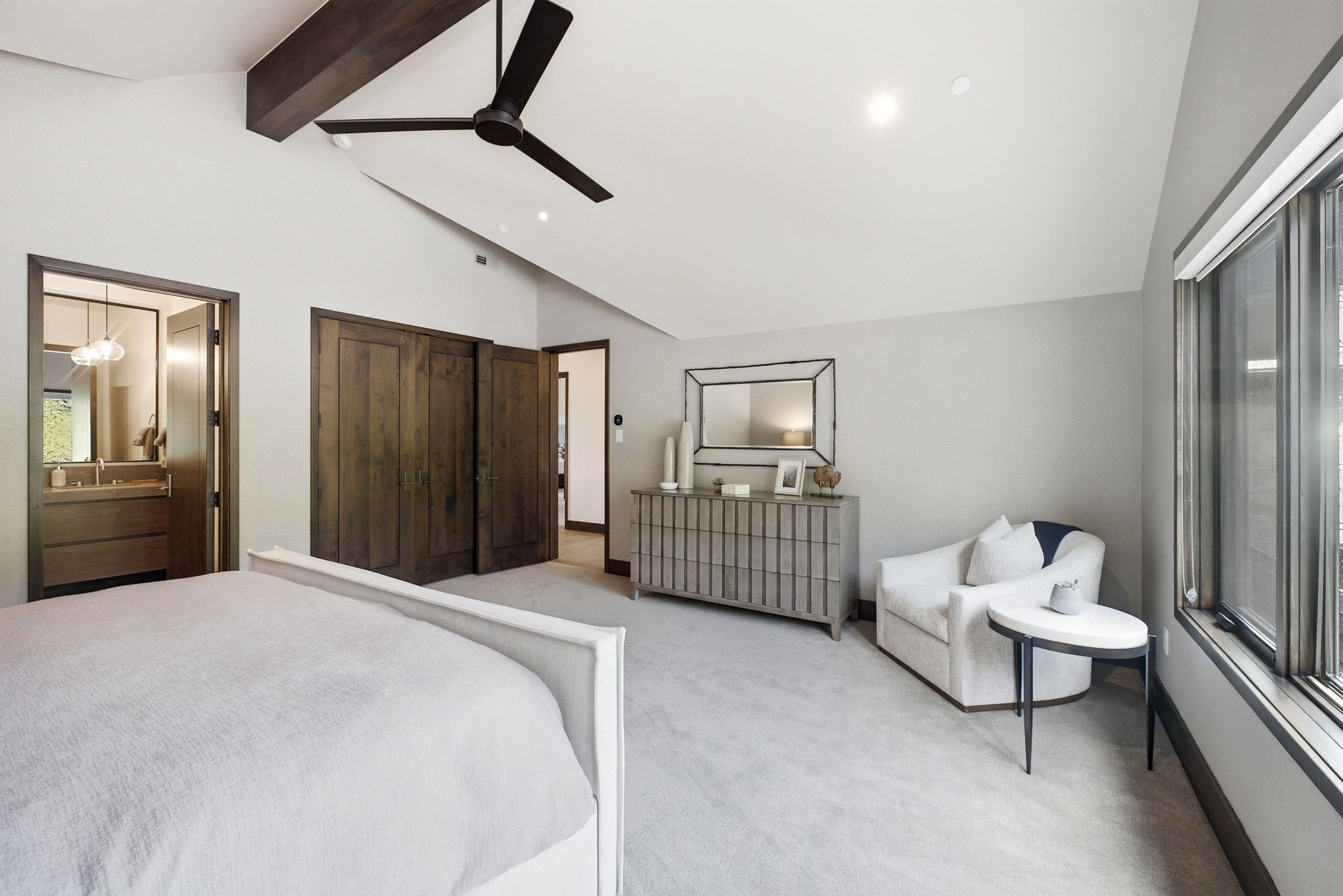 Vaulted ceiling with exposed wood beam and modern ceiling fan