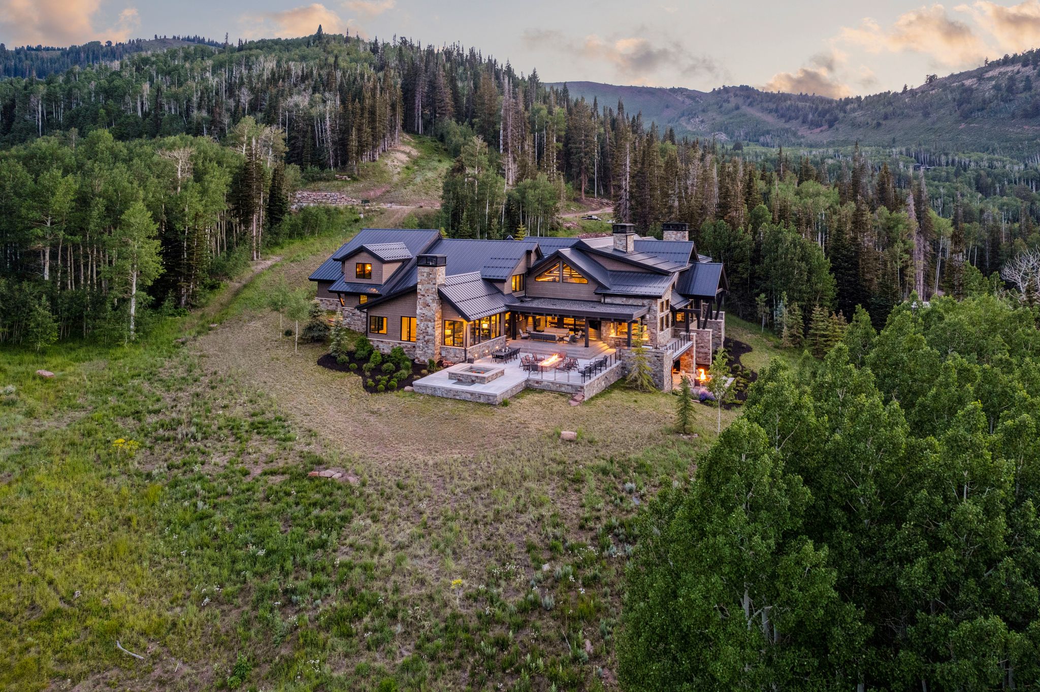 Expansive mountain estate featuring a multi-level stone and wood-clad exterior