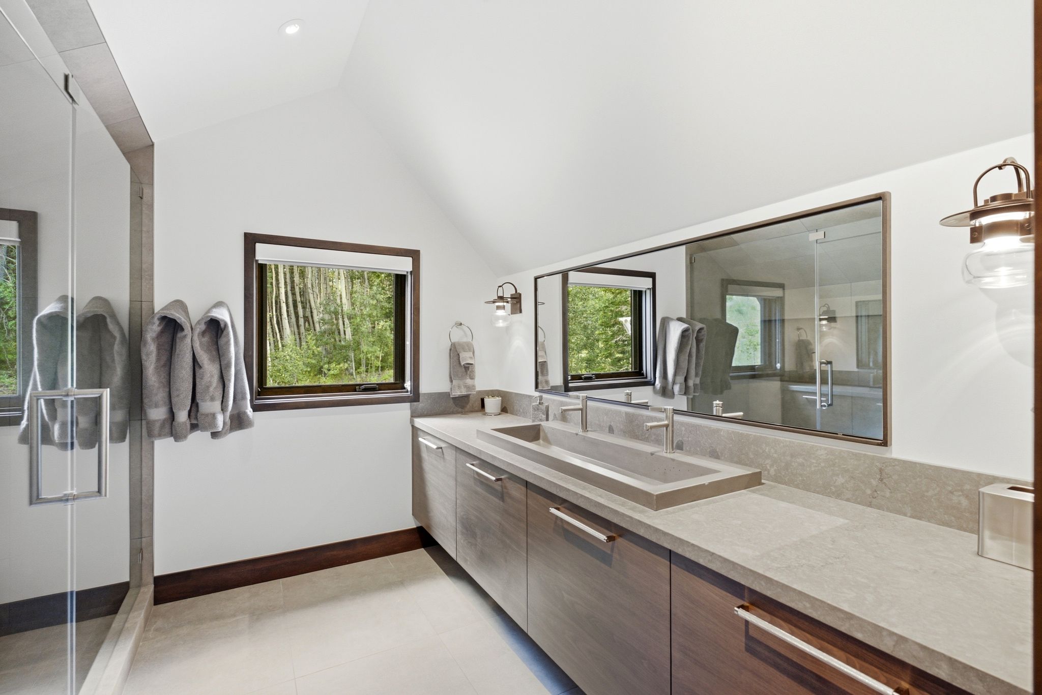 Modern bathroom featuring a double vanity with integrated rectangular sink and light grey countertop