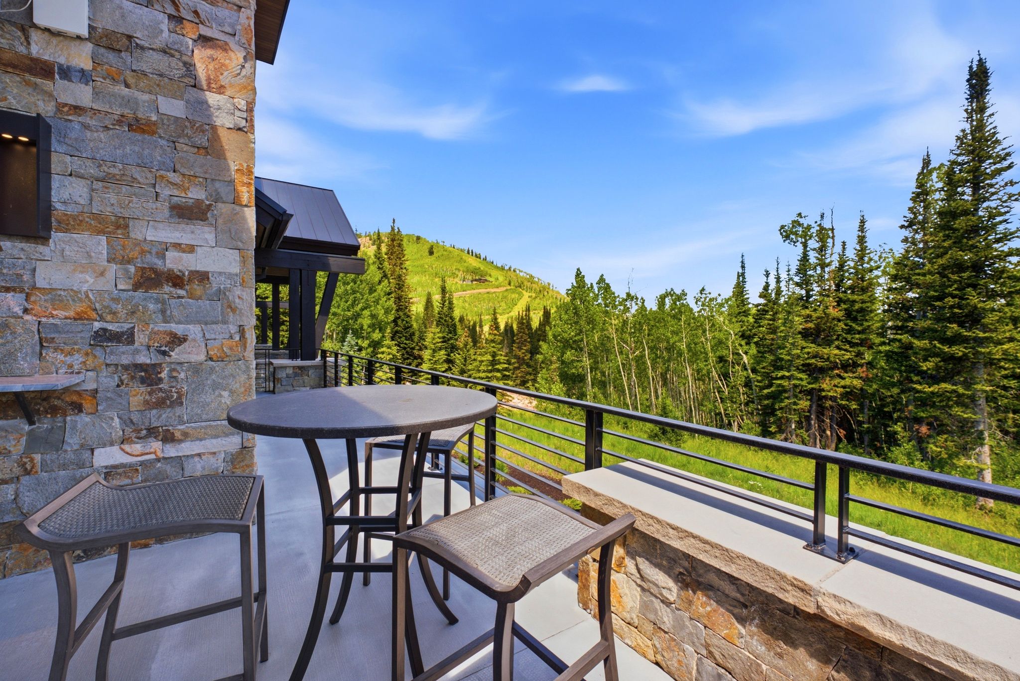 Stone exterior wall featuring an integrated outdoor sconce