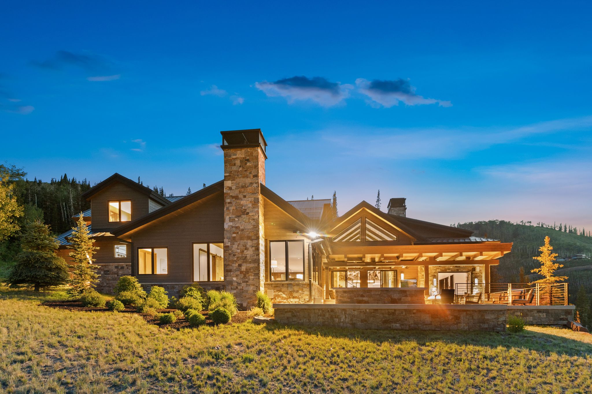 Contemporary mountain-style residence featuring a stone and wood exterior