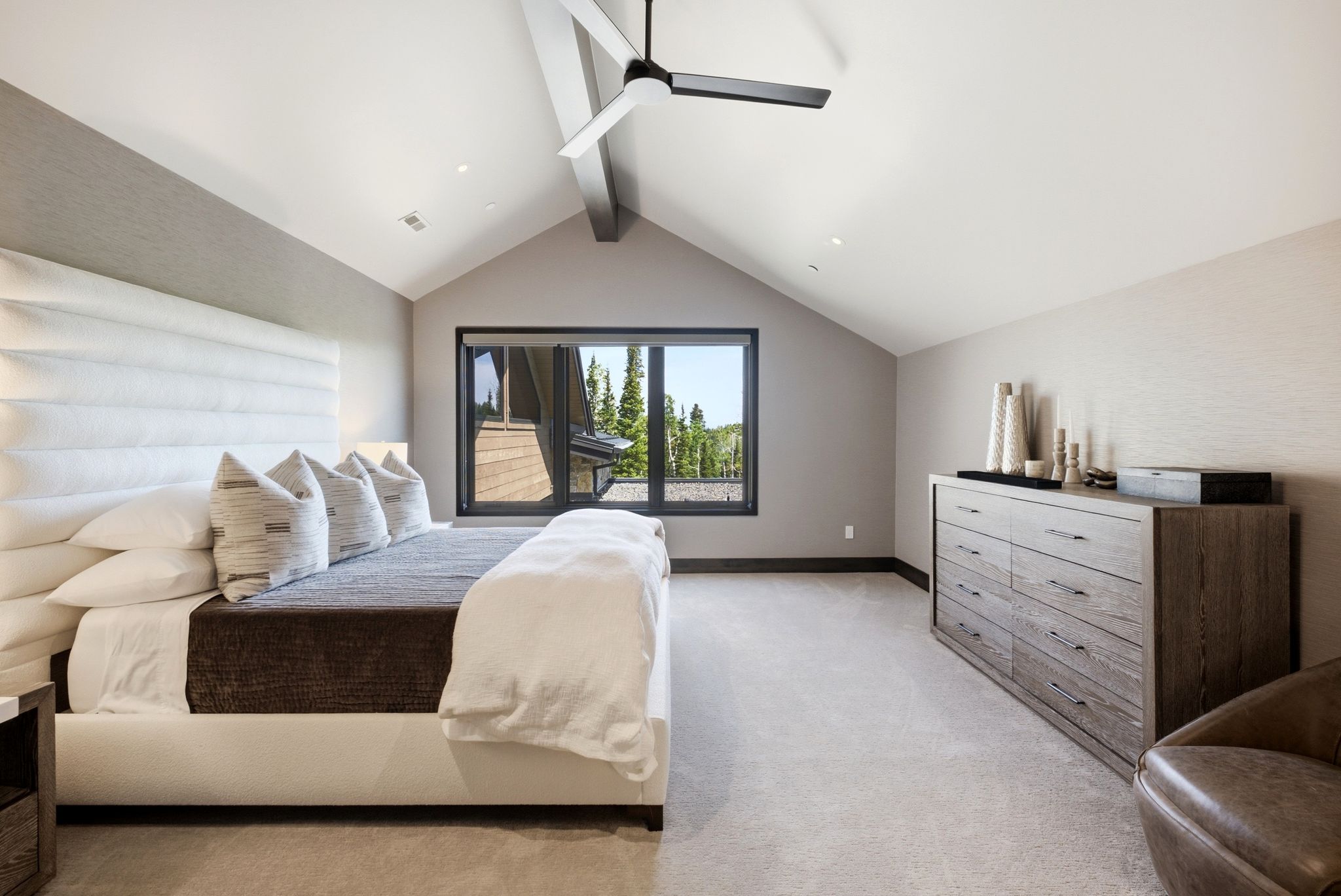 Vaulted ceilings featuring a contemporary ceiling fan, recessed lighting, and a large window