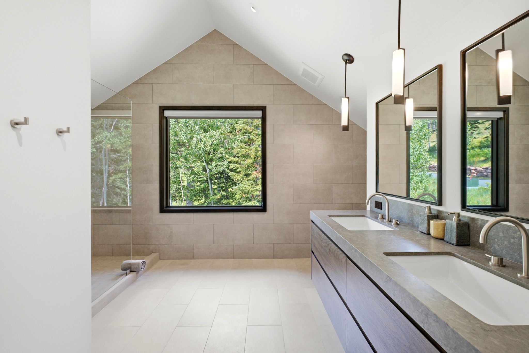 Contemporary bathroom featuring a dual vanity with integrated sinks, stone countertop, and wood-finish cabinetry