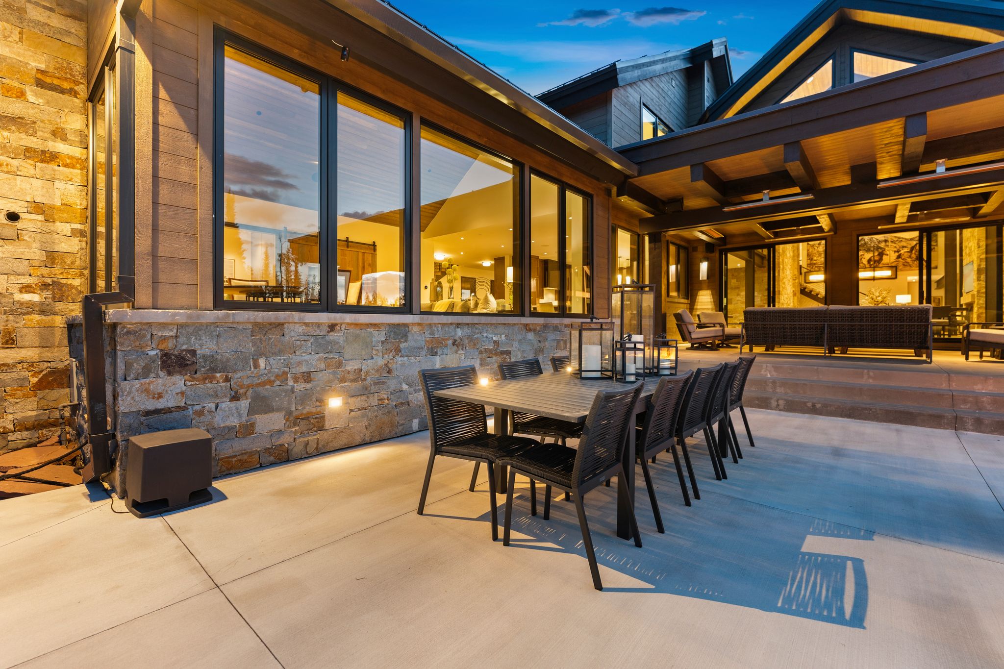 Expansive stone patio featuring an outdoor dining area