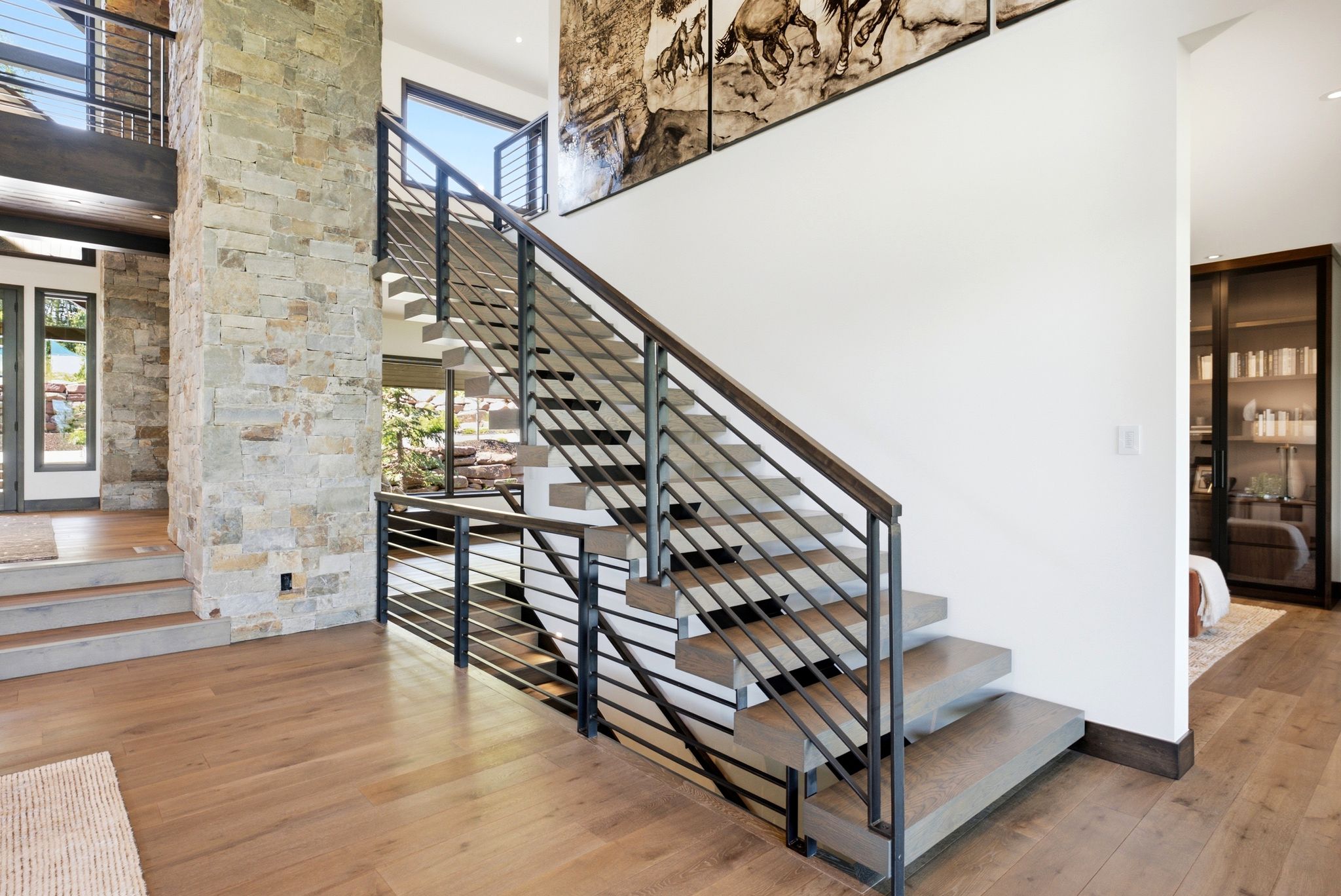 Contemporary floating staircase with metal railing system