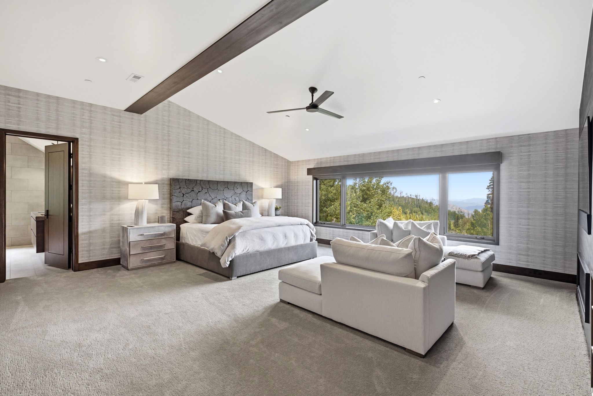 Vaulted ceiling with exposed wood beam and recessed lighting