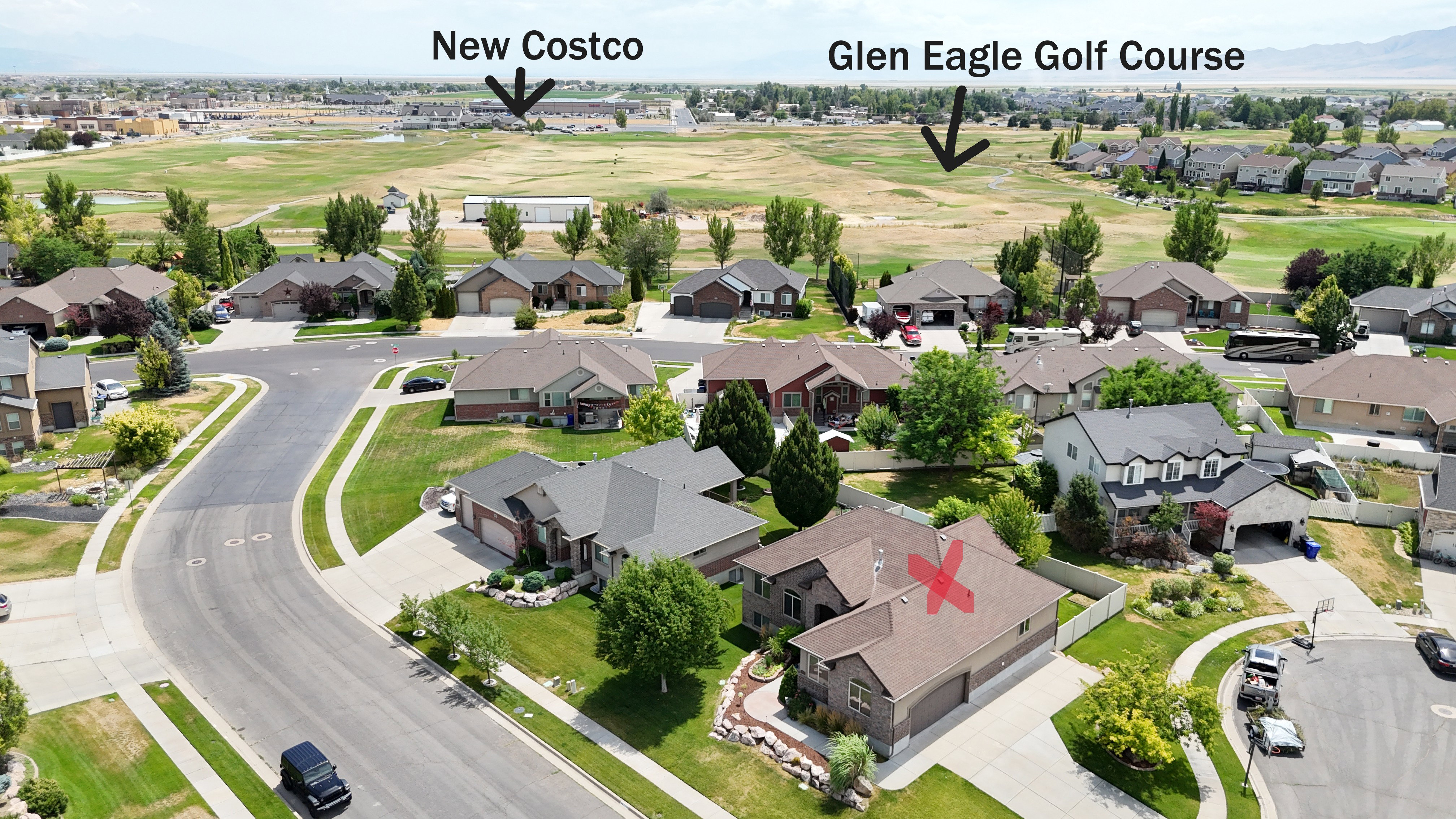 Aerial perspective of a residential neighborhood featuring single-family homes with landscaped yards