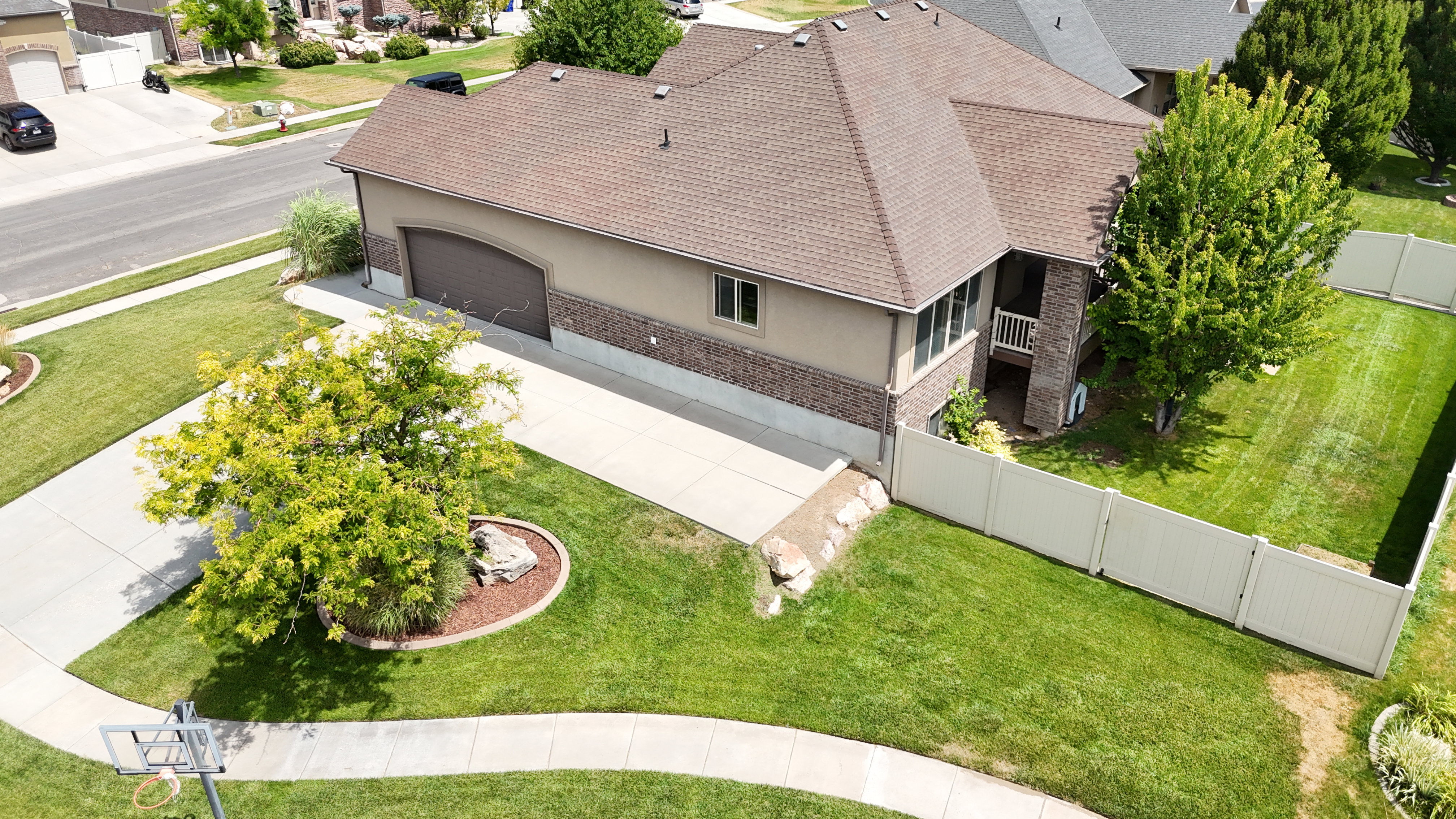 Two-story residence featuring a composite shingle roof, a two-car garage, and a brick and stucco exterior