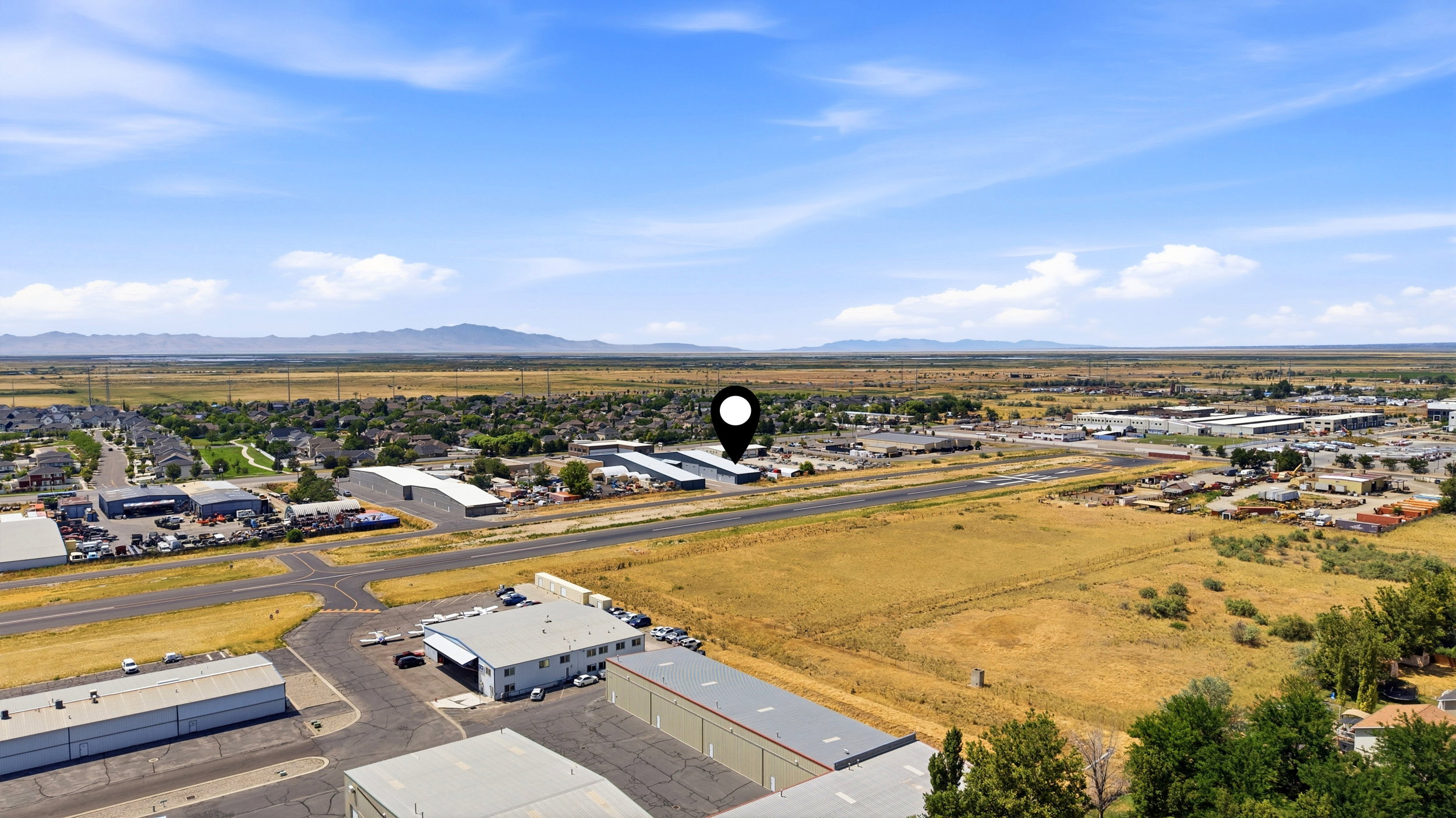 Expansive land parcel featuring open fields and distant mountain ranges