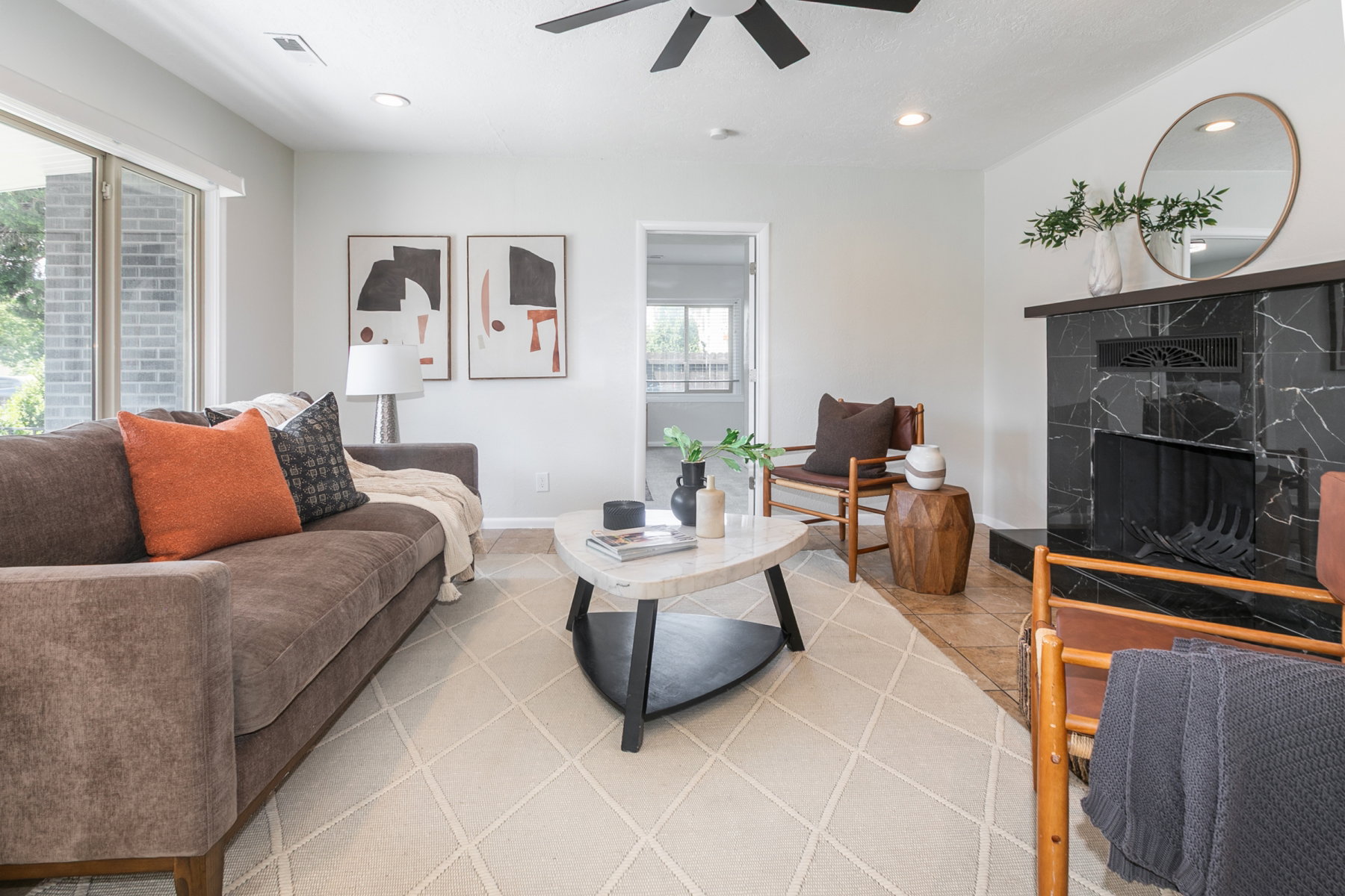 Living area featuring a black marble-style fireplace, recessed lighting, and a ceiling fan
