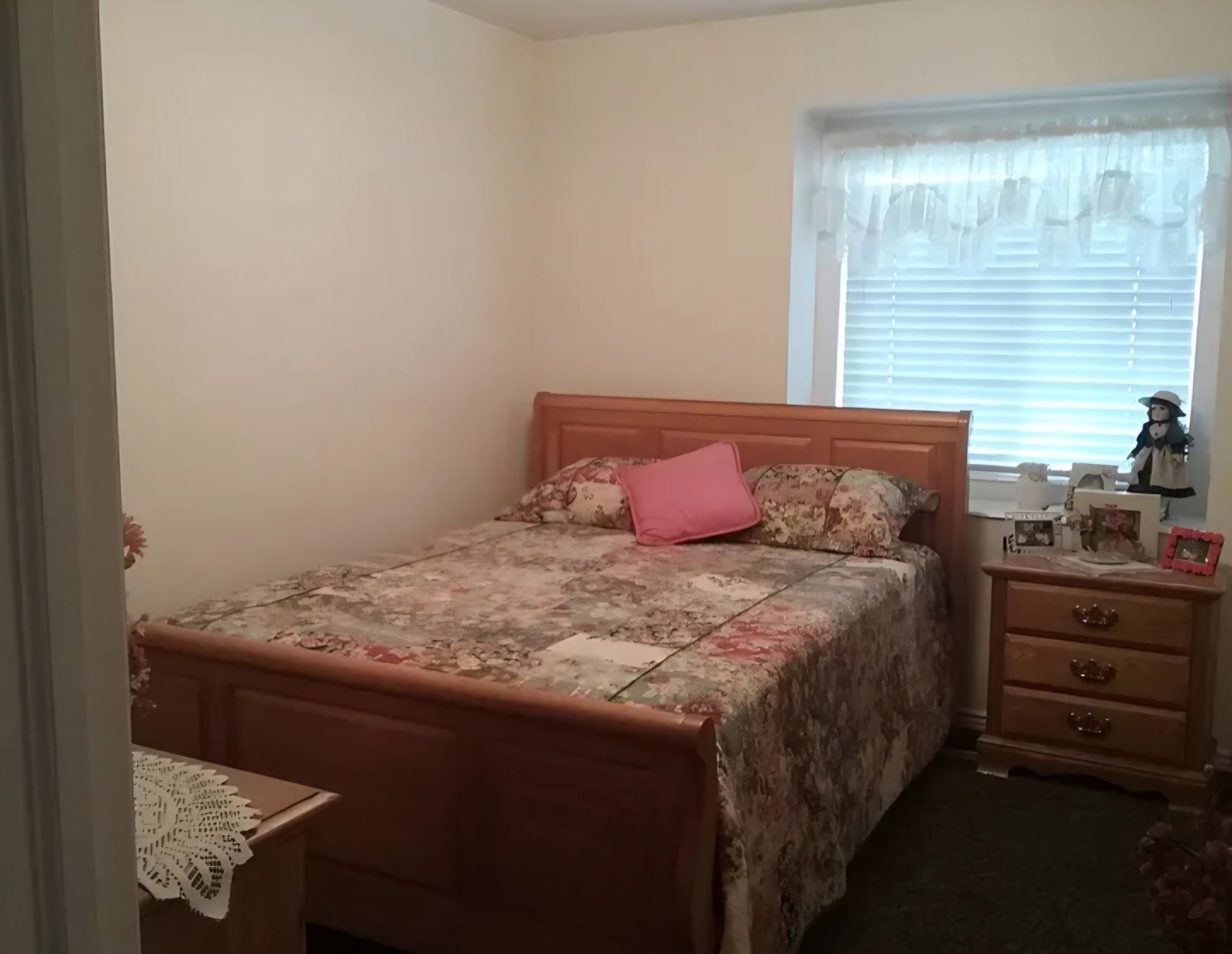 Bedroom featuring a single window with blinds and valance