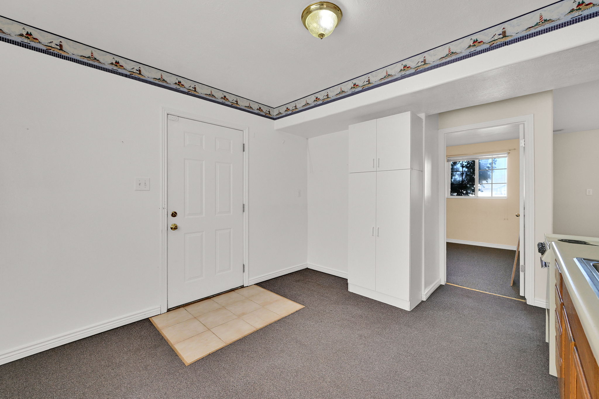 White entry door with a multi-pane design and brass hardware