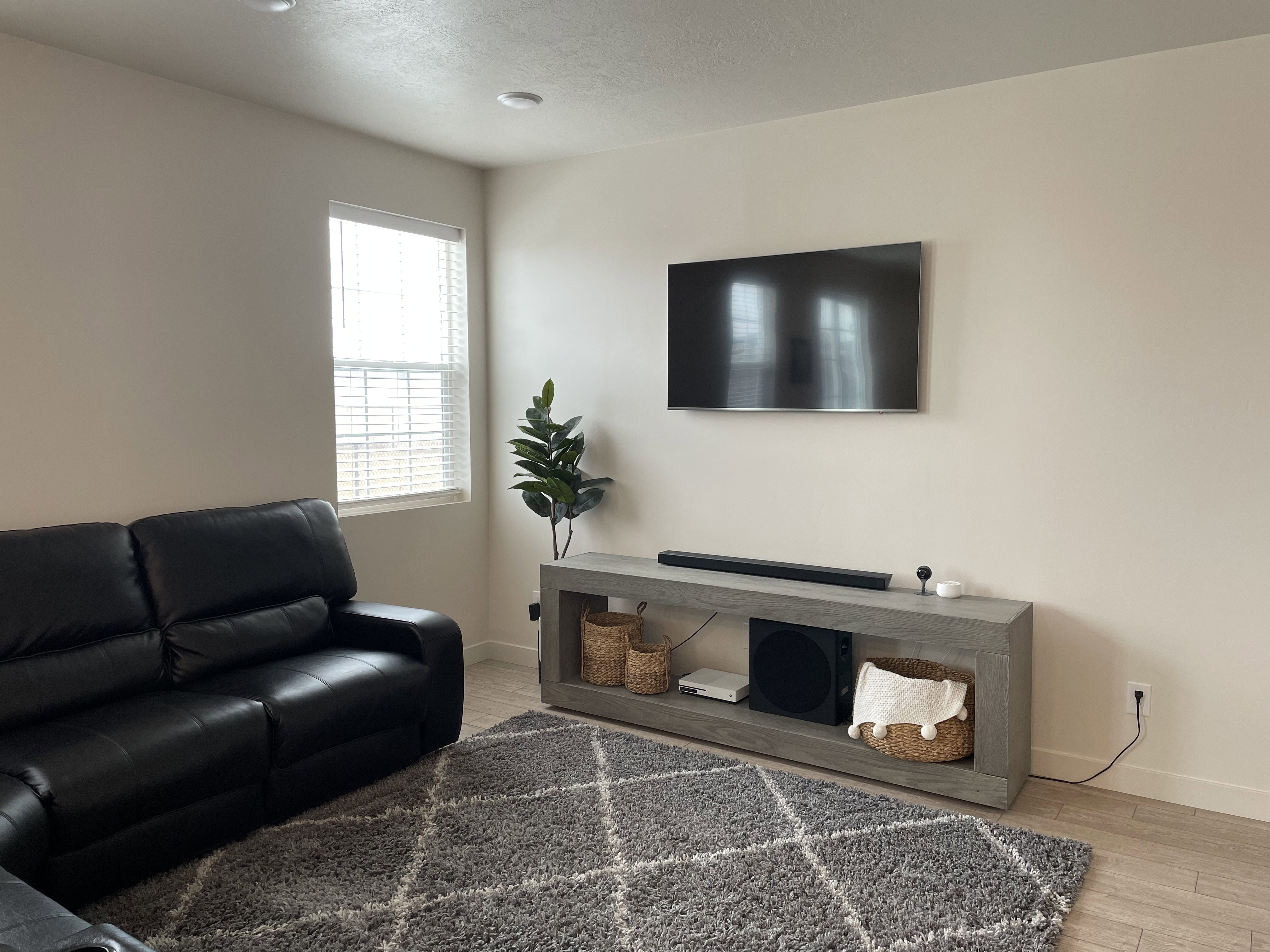 Neutral-toned walls complement recessed lighting and wood-finish flooring