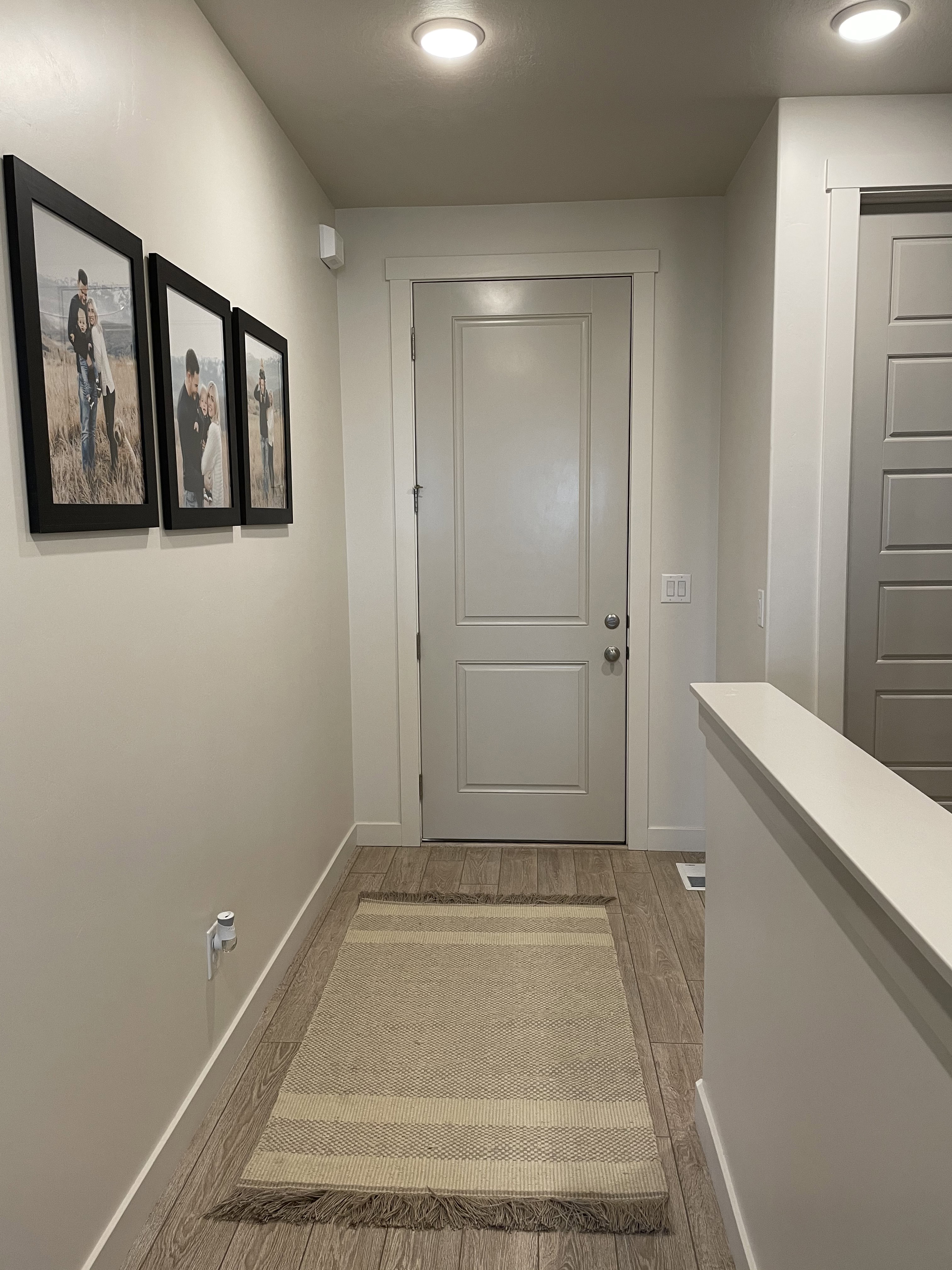 Entryway featuring wood-finish flooring, recessed lighting, white trim, and a paneled interior door