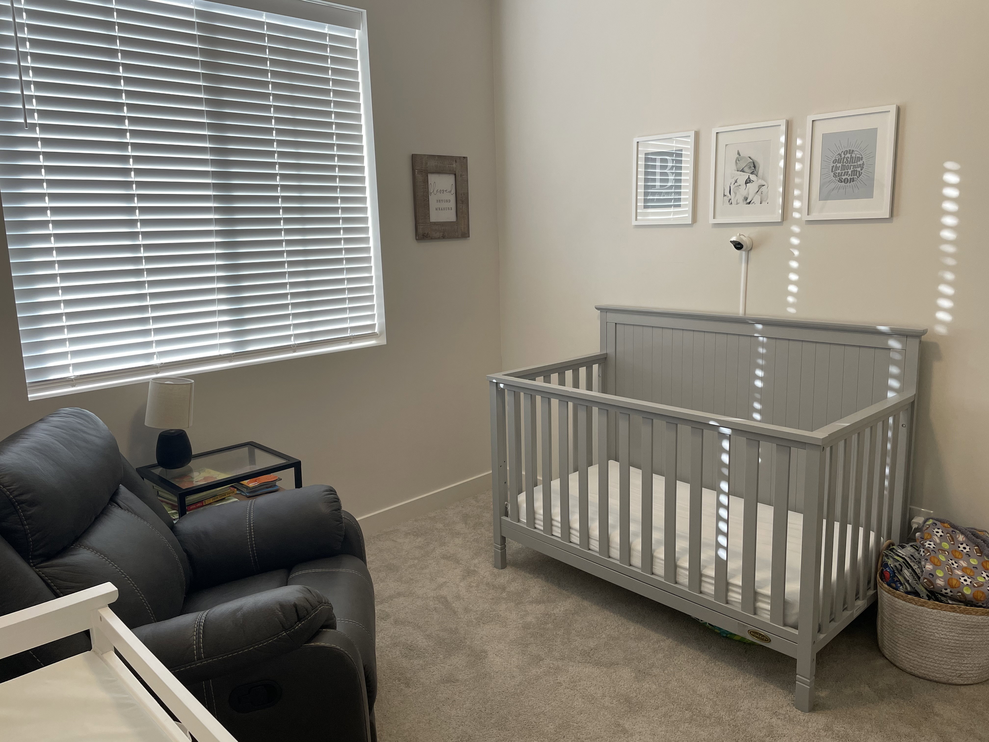 Carpeted room with neutral wall tones and a window featuring horizontal blinds