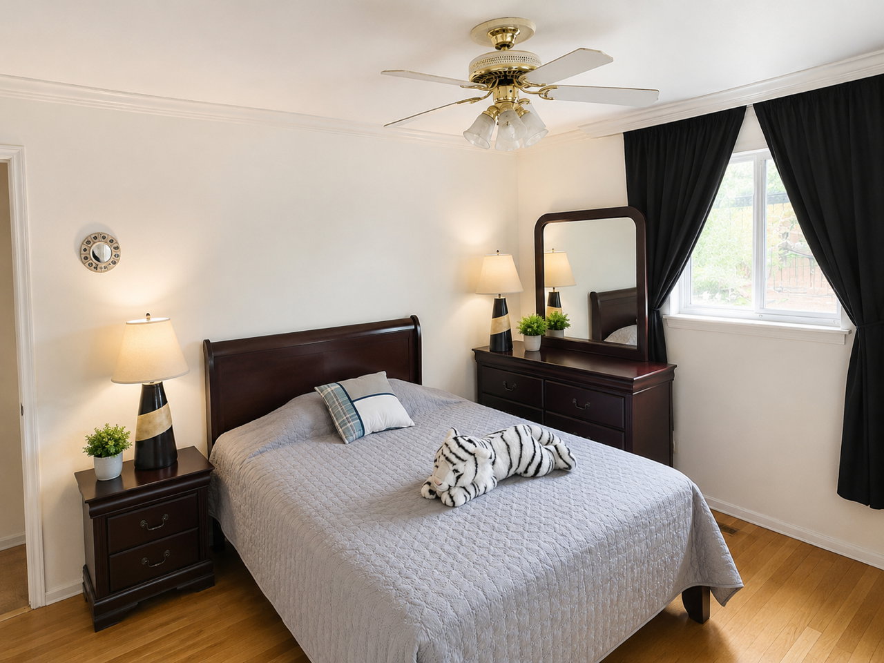 Light-toned wood-finish flooring provides a bright base for this room featuring white walls and a white ceiling with crown molding