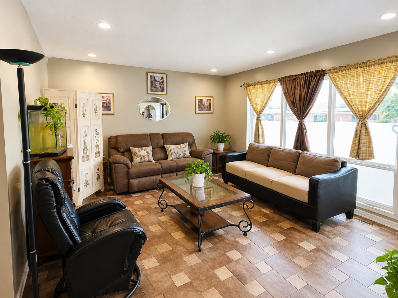 Spacious living area featuring large picture windows, recessed lighting, and tile flooring