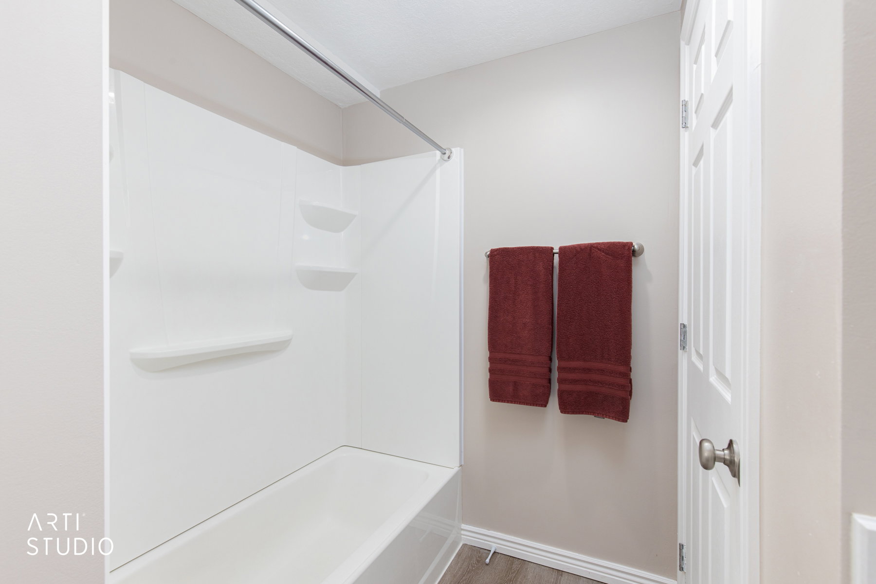 White bathtub and shower surround with integrated shelving