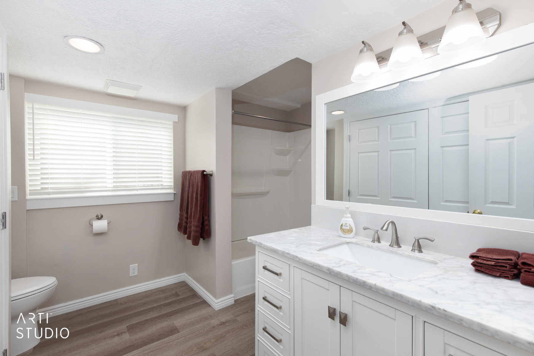 Bathroom featuring a vanity with a rectangular undermount sink, a white countertop, and a large framed mirror