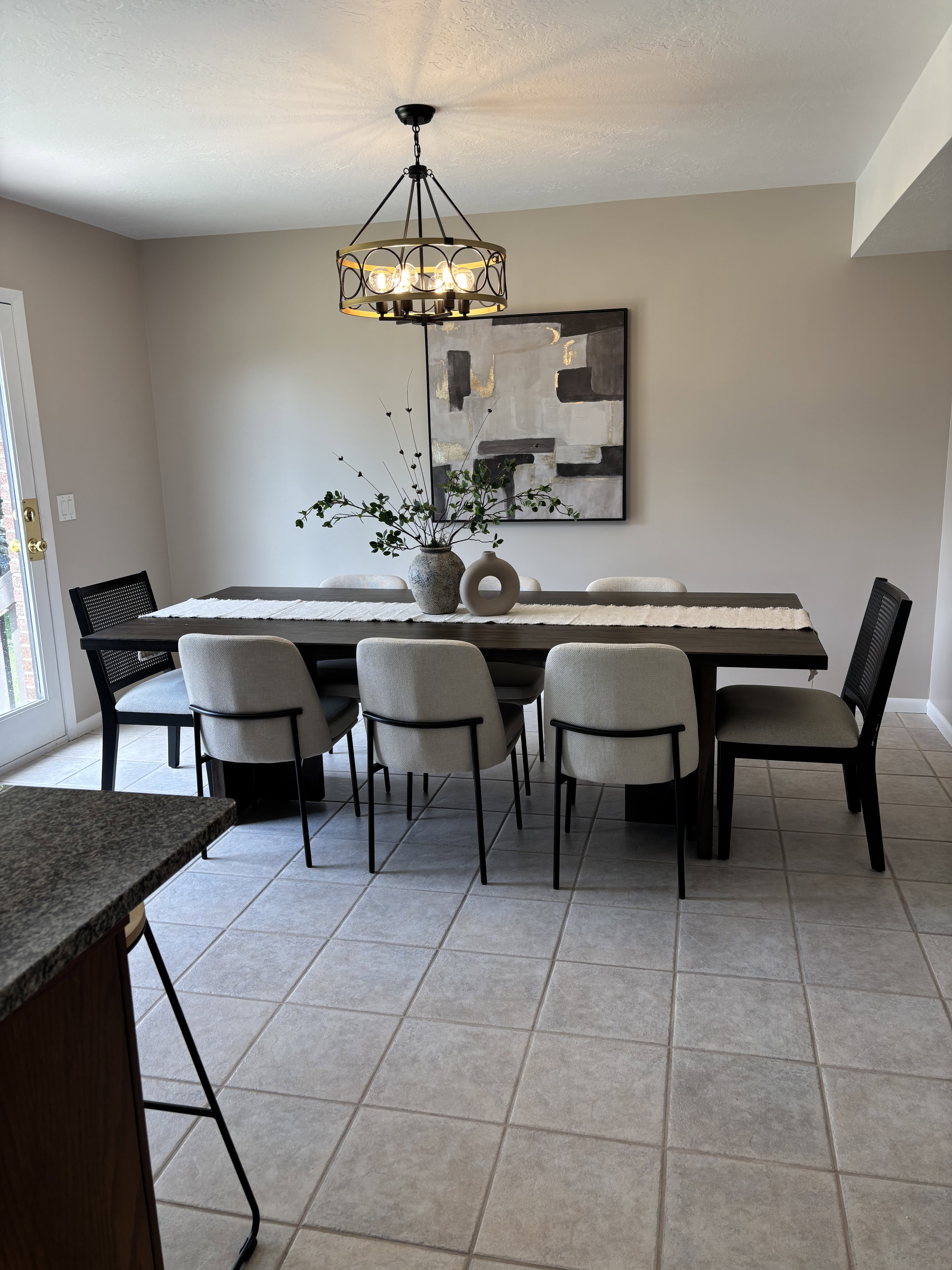 Dining area featuring square tile flooring and a decorative chandelier