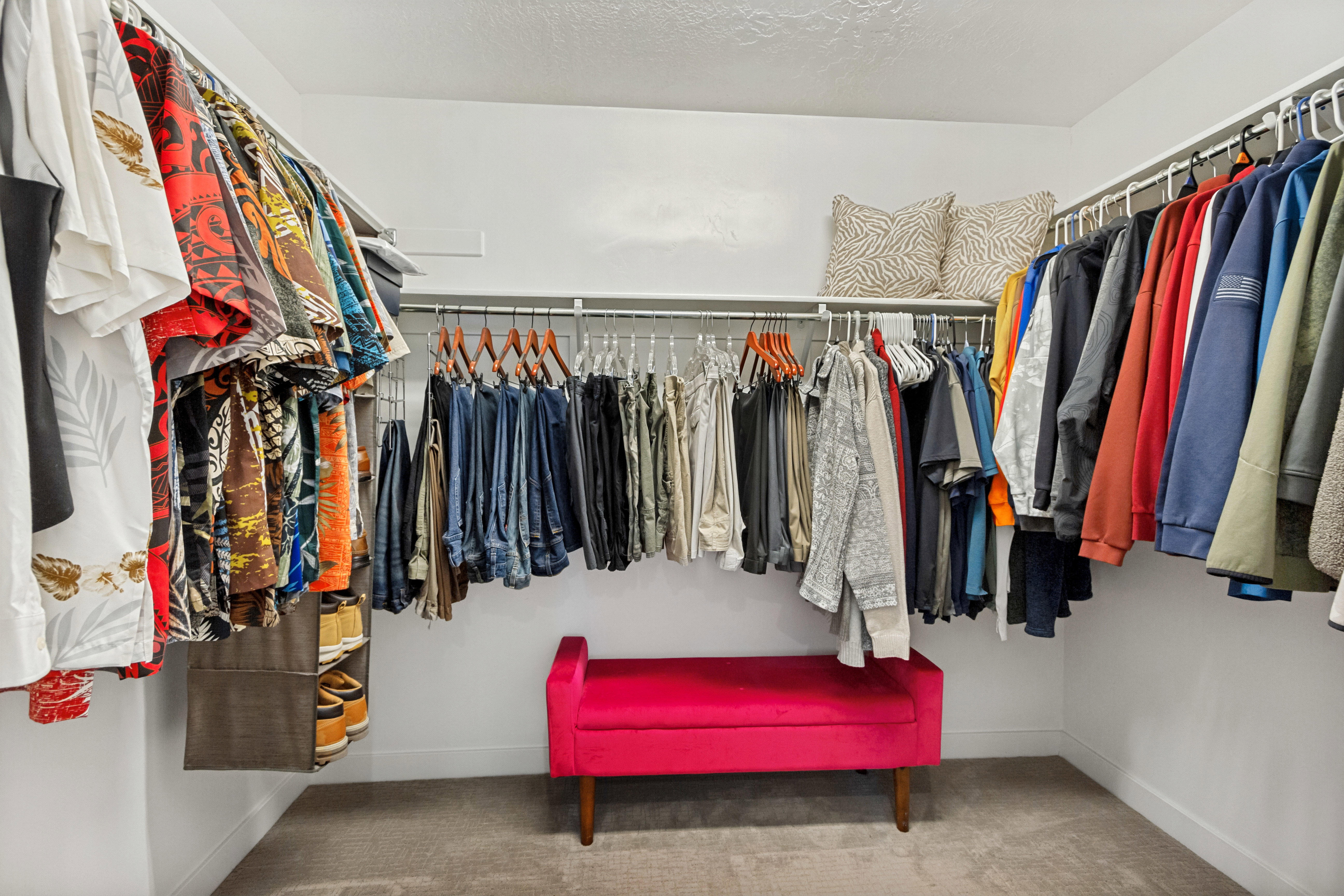 Custom closet system featuring multiple hanging rods and integrated shelving
