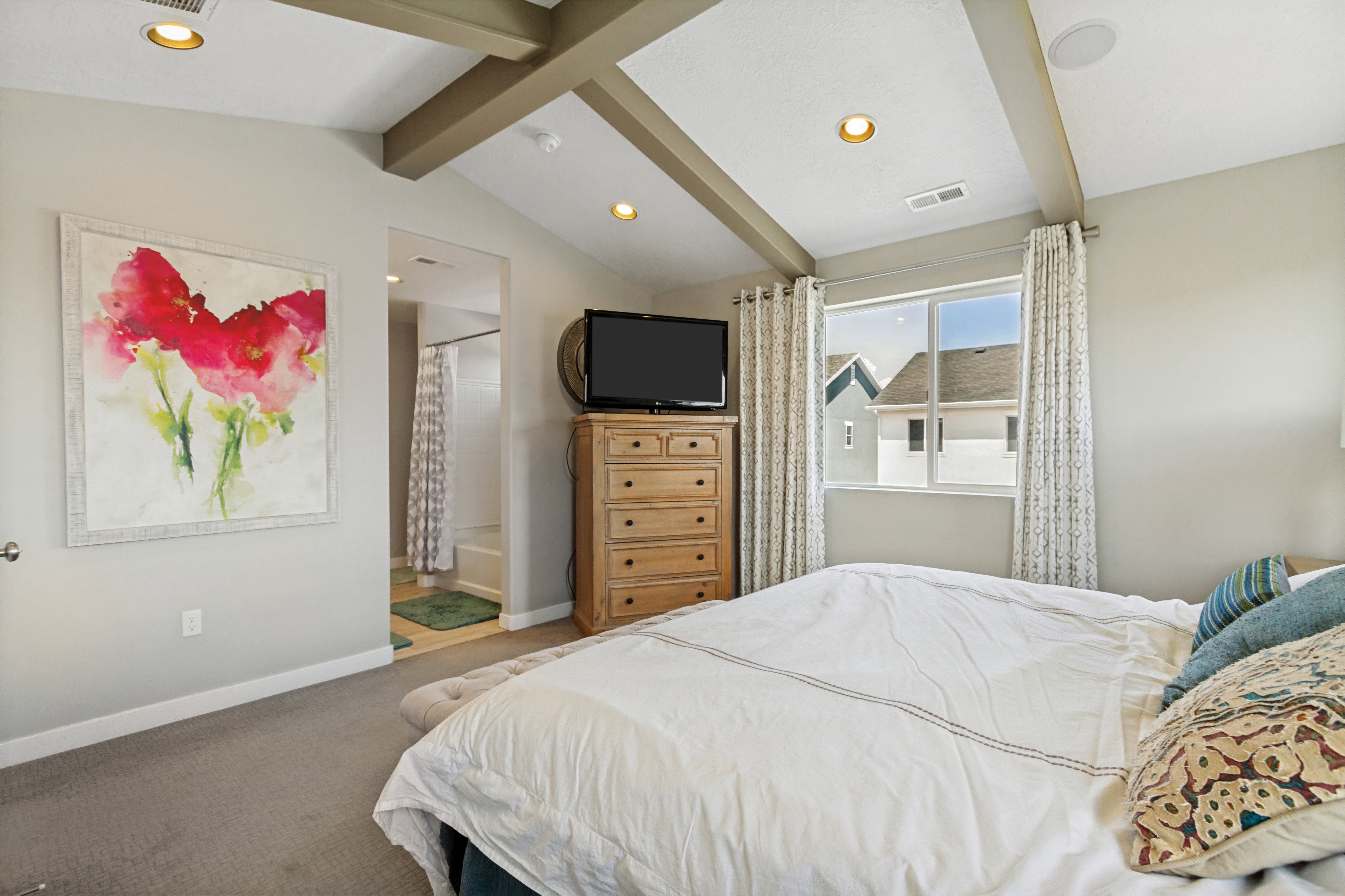 Vaulted ceiling with exposed beams and recessed lighting