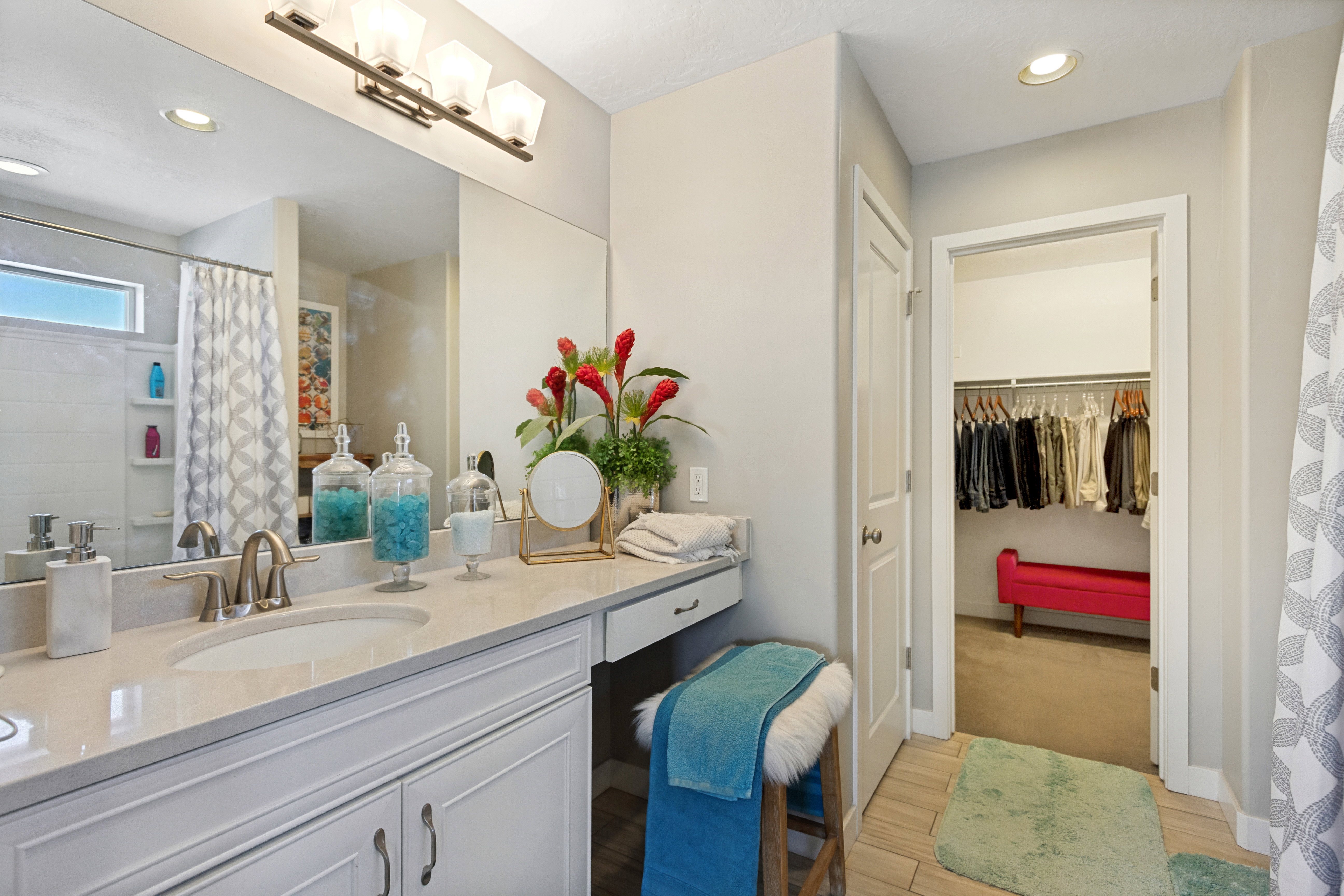 Bathroom vanity featuring a single undermount sink, brushed nickel faucet, and light-colored countertop