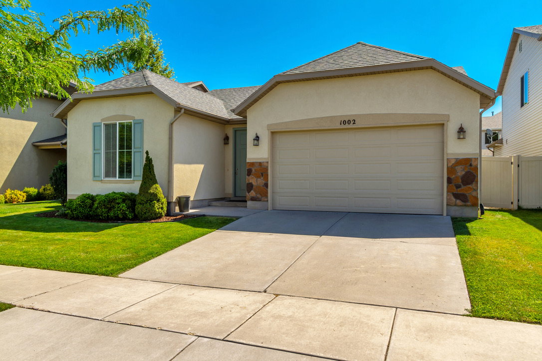 Stucco exterior with stone accents and a two-car garage
