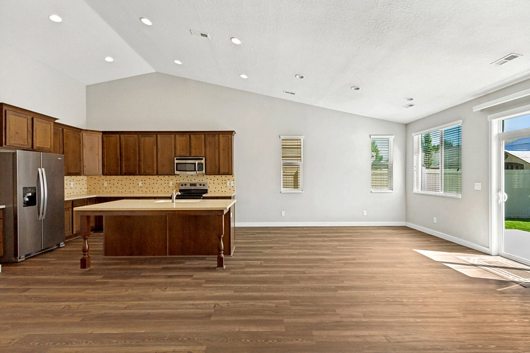 Open-concept living space with vaulted ceilings and recessed lighting