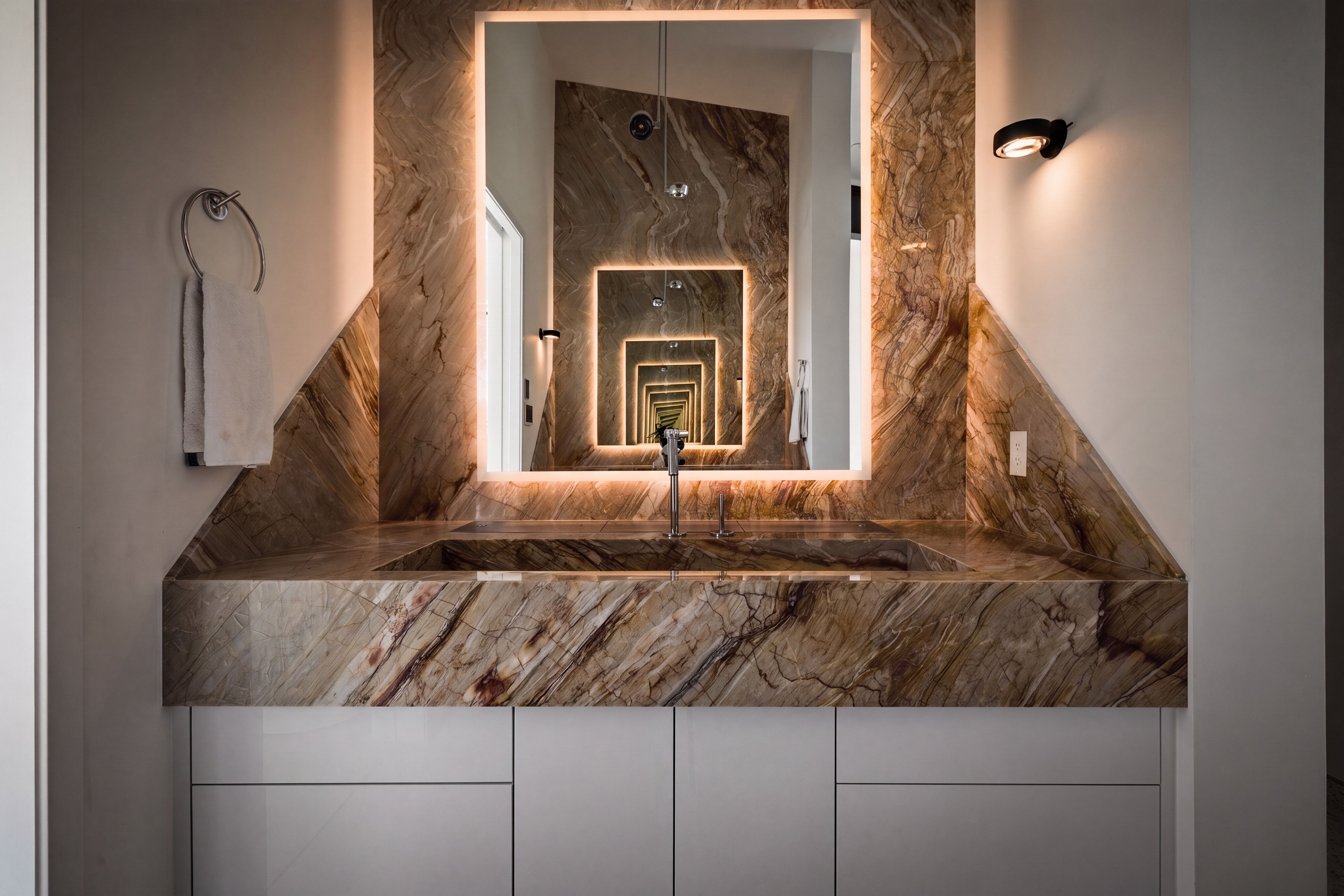 Integrated stone vanity with a rectangular basin and a modern faucet