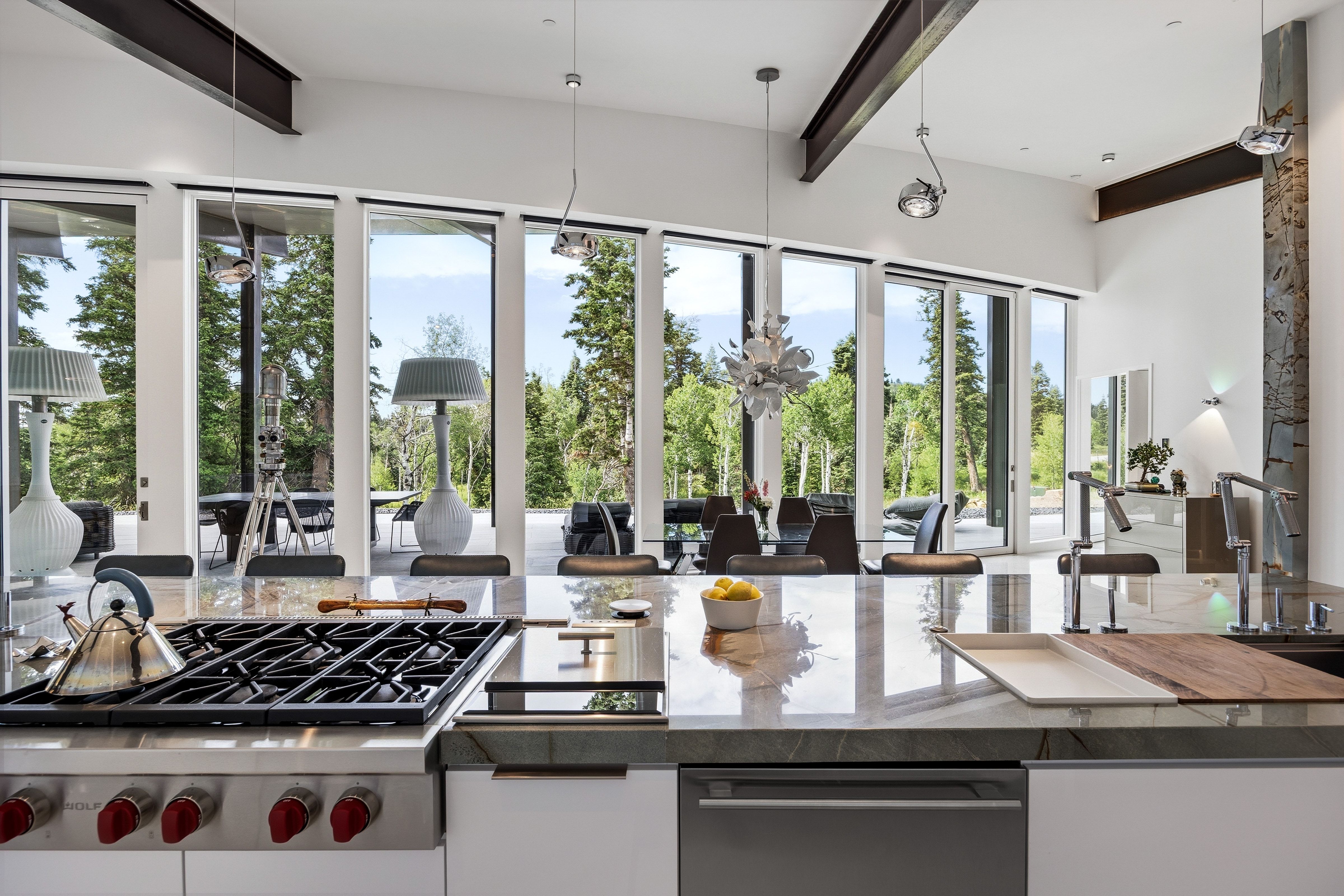 Modern kitchen with a large central island featuring a gas cooktop and integrated sink area