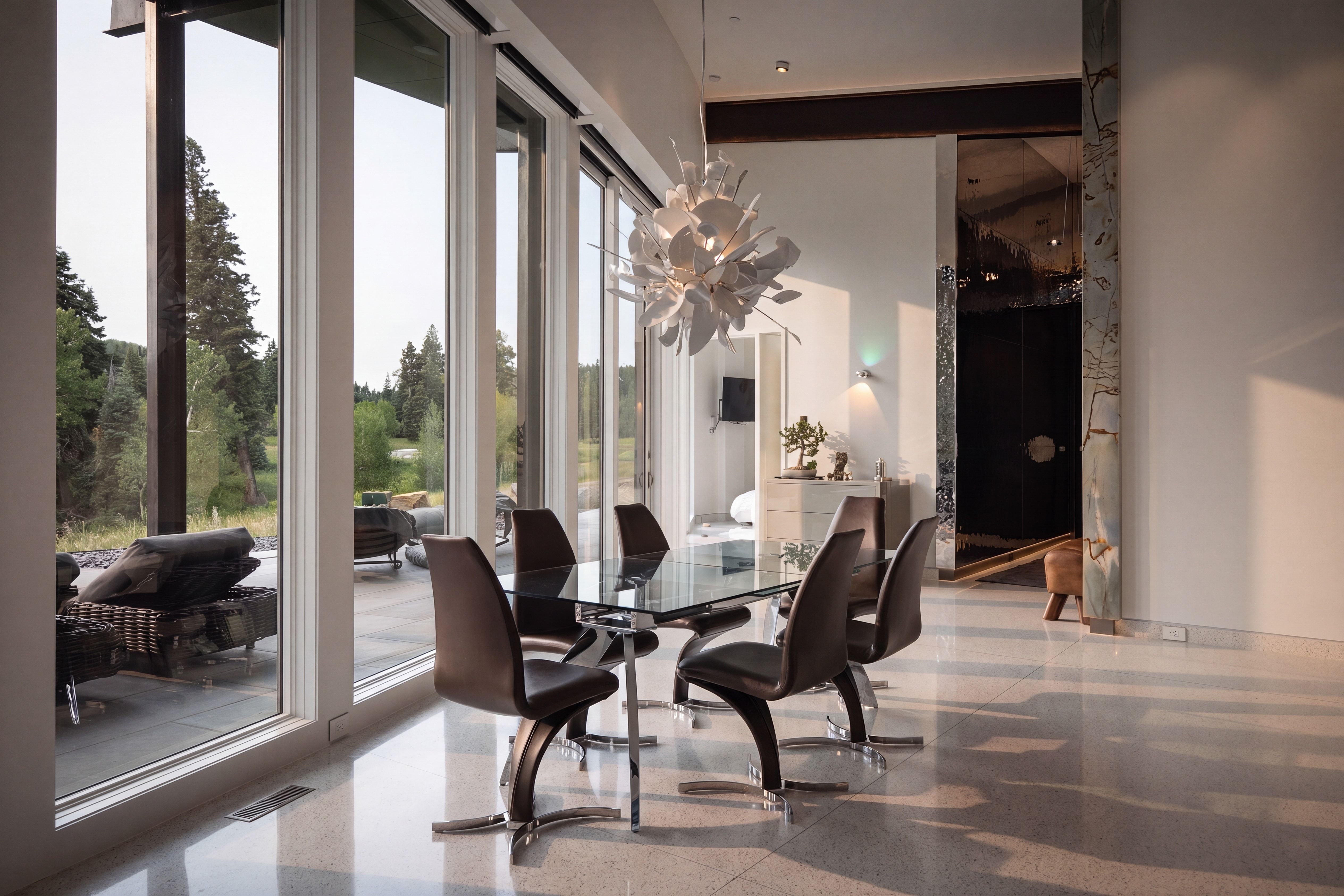 Spacious interior featuring large format windows, high ceilings, polished concrete flooring, a contemporary chandelier, and a mirrored accent wall