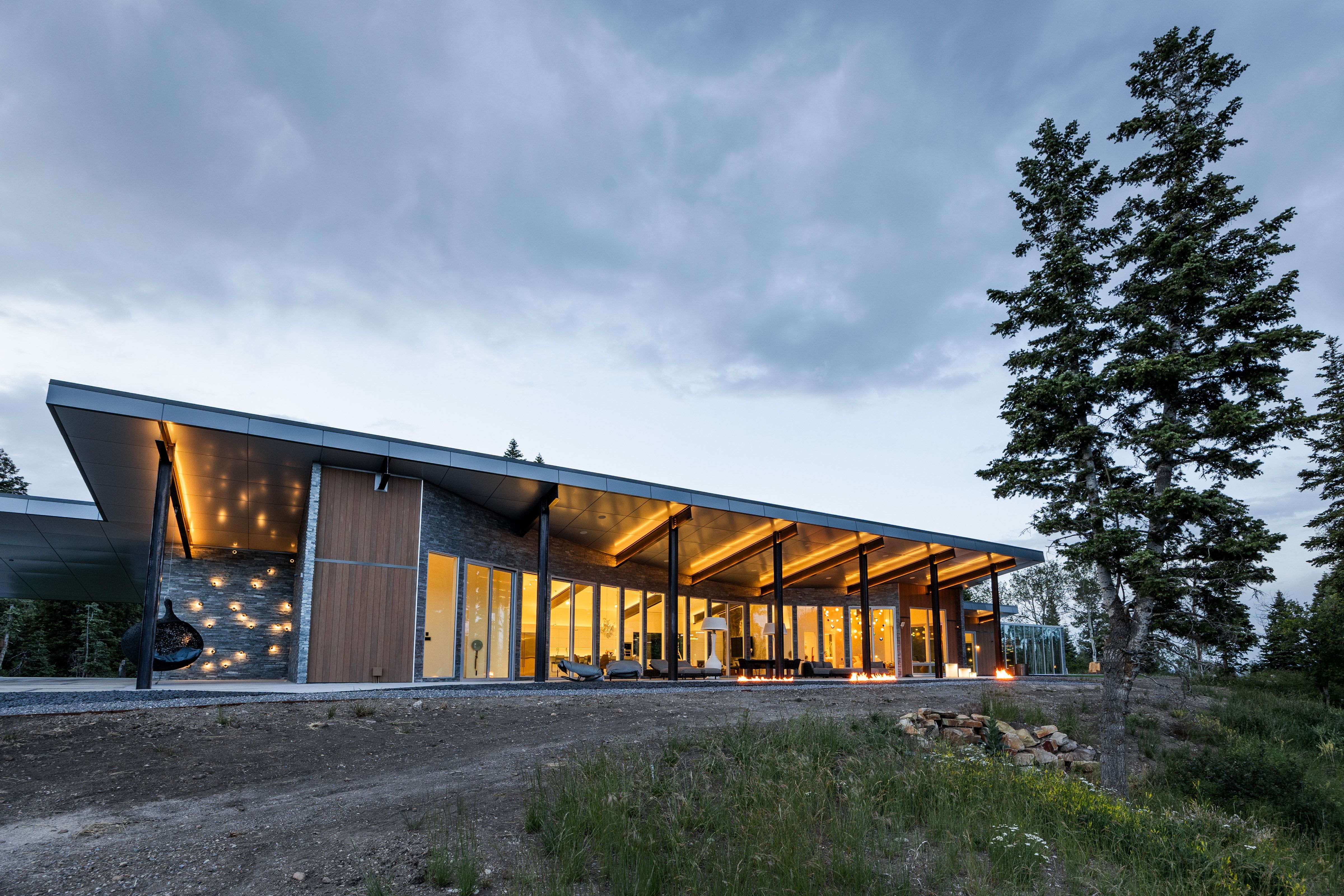Contemporary architectural design featuring a prominent shed roofline and extensive glass-paneled walls