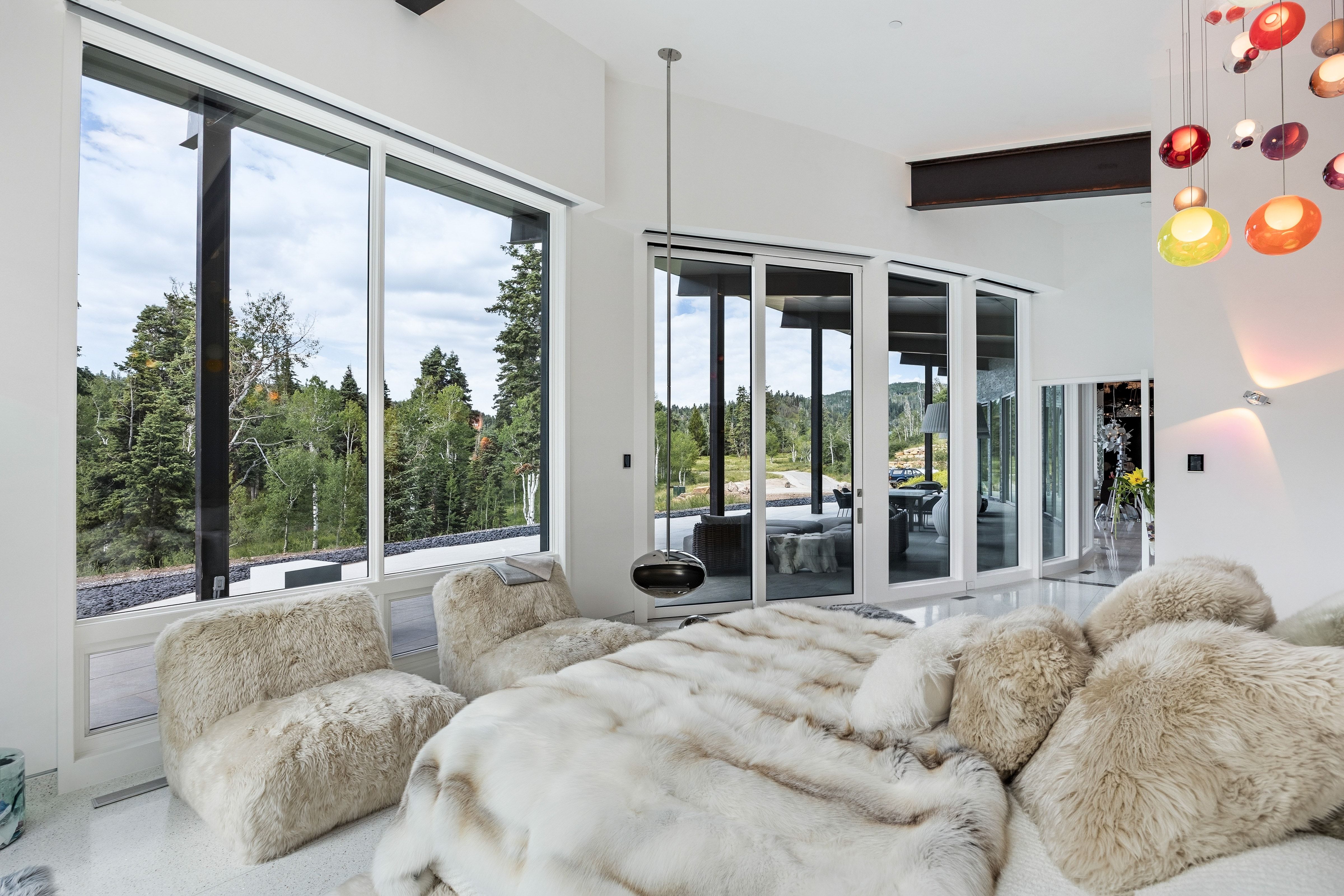Spacious interior featuring large format floor tiles and expansive window walls