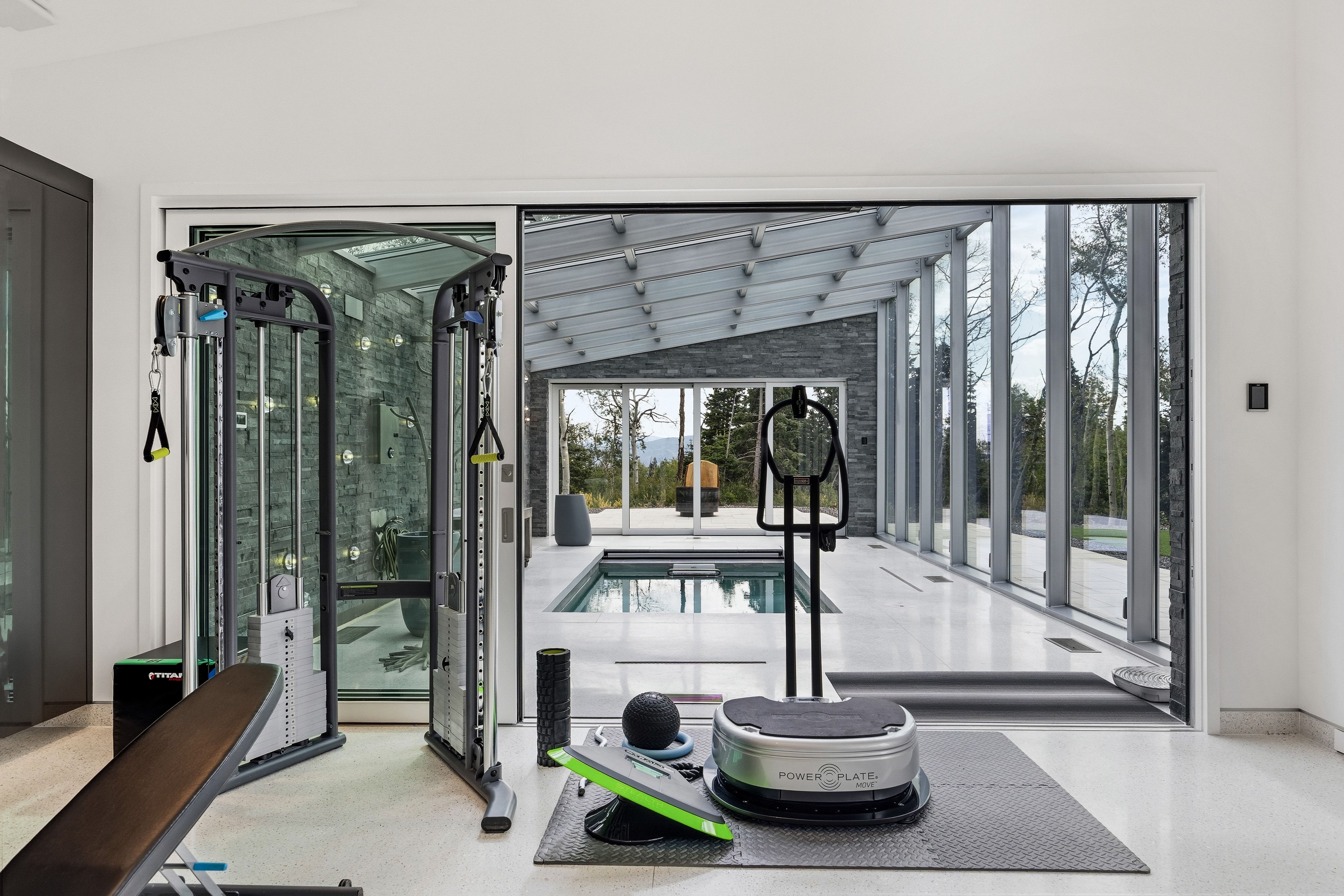 Open concept space featuring a large sliding glass door, white floor, and a stone wall accent