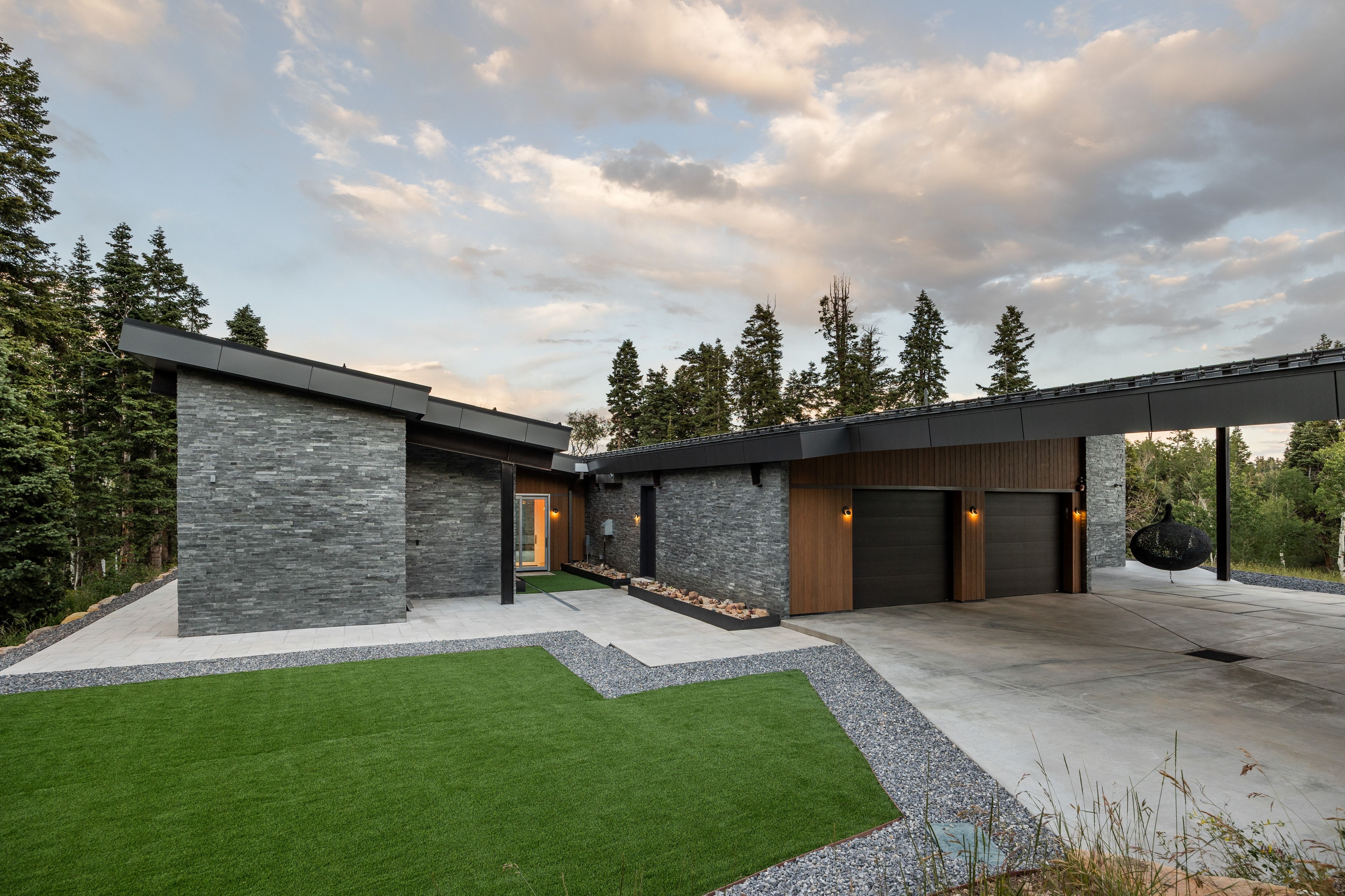 Modern architectural design featuring stacked stone and wood-look siding