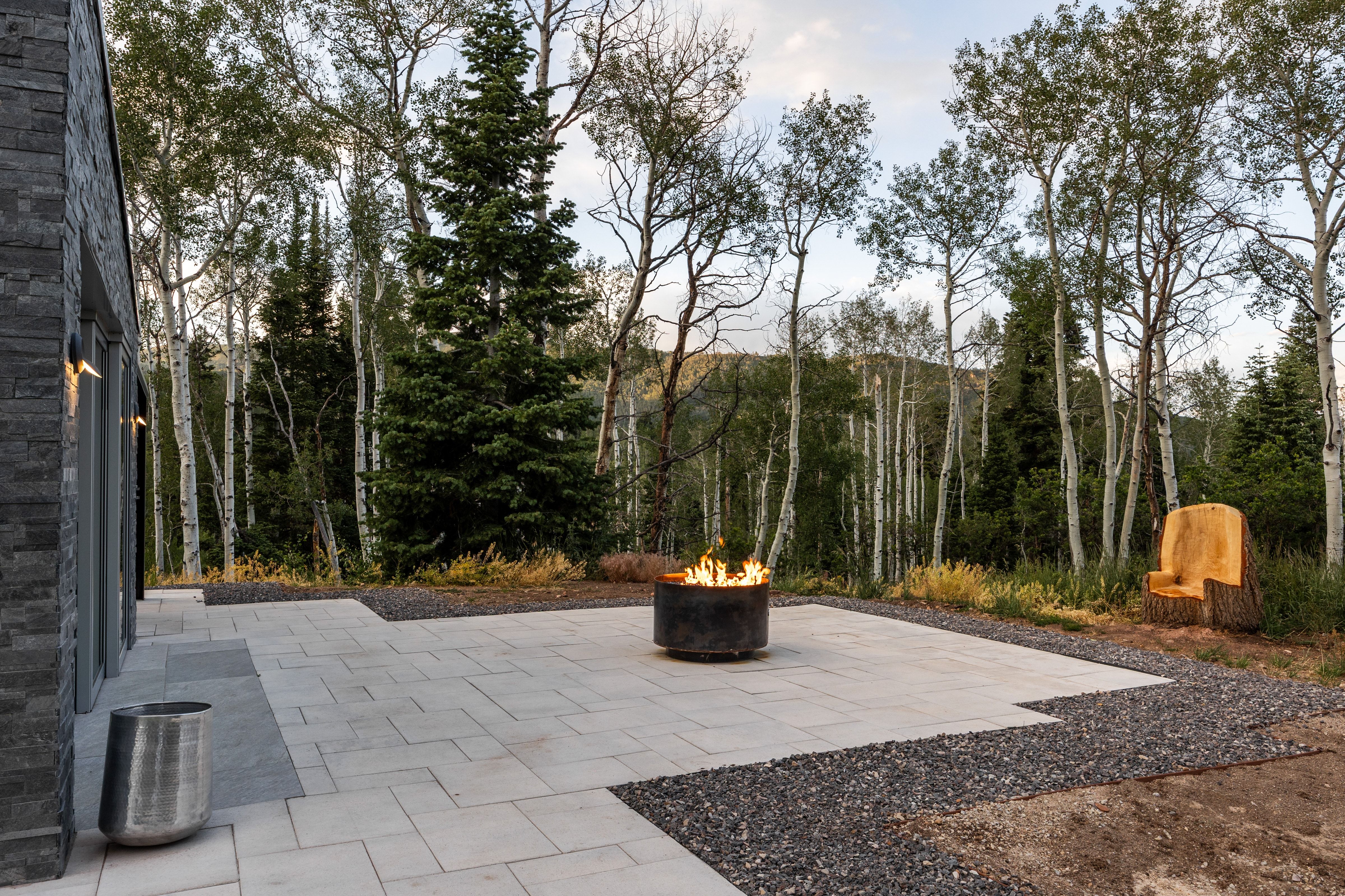 Expansive outdoor patio featuring light-toned pavers and dark gravel accents