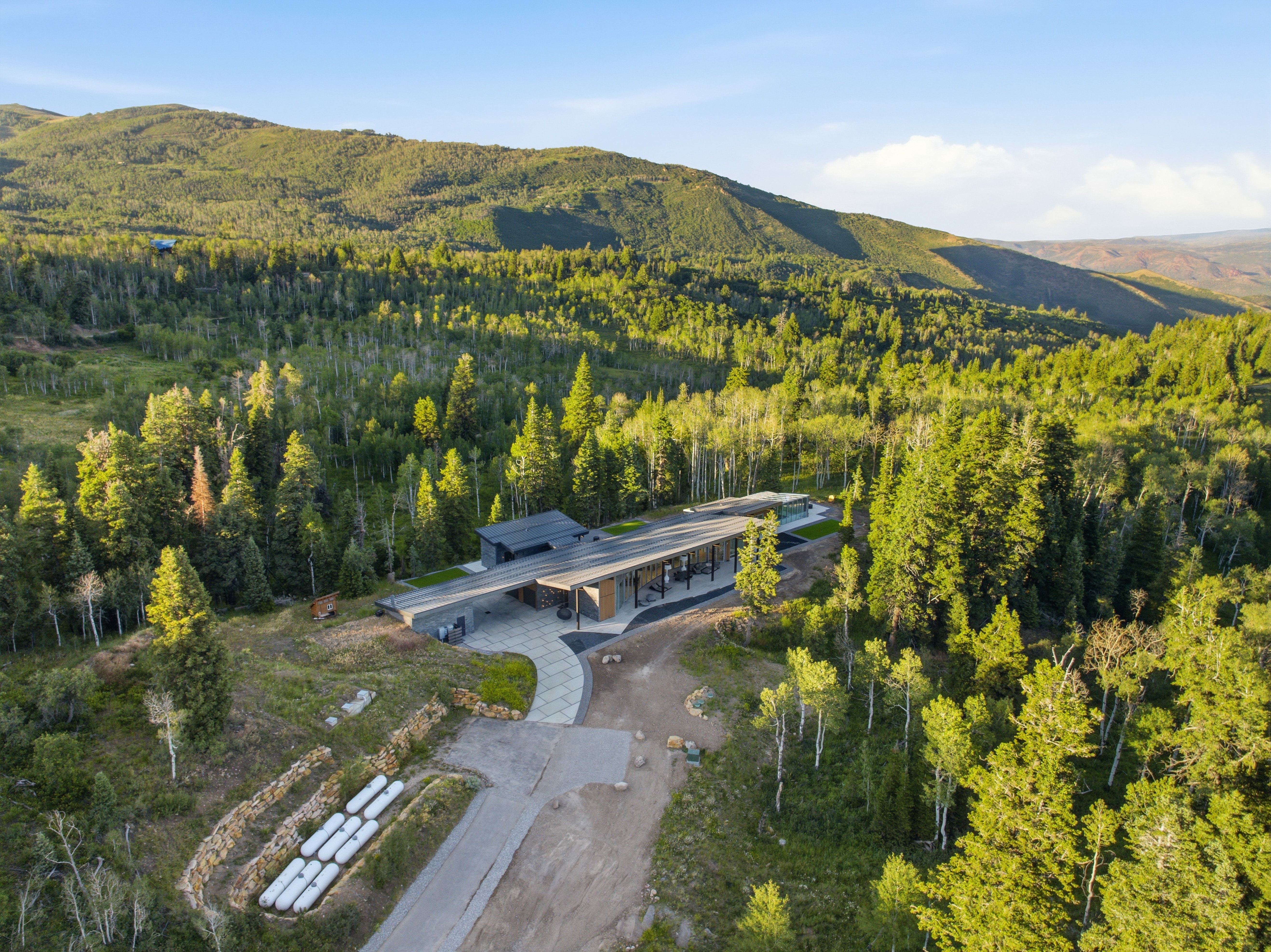 Modern architectural home featuring a flat roofline and a stone facade
