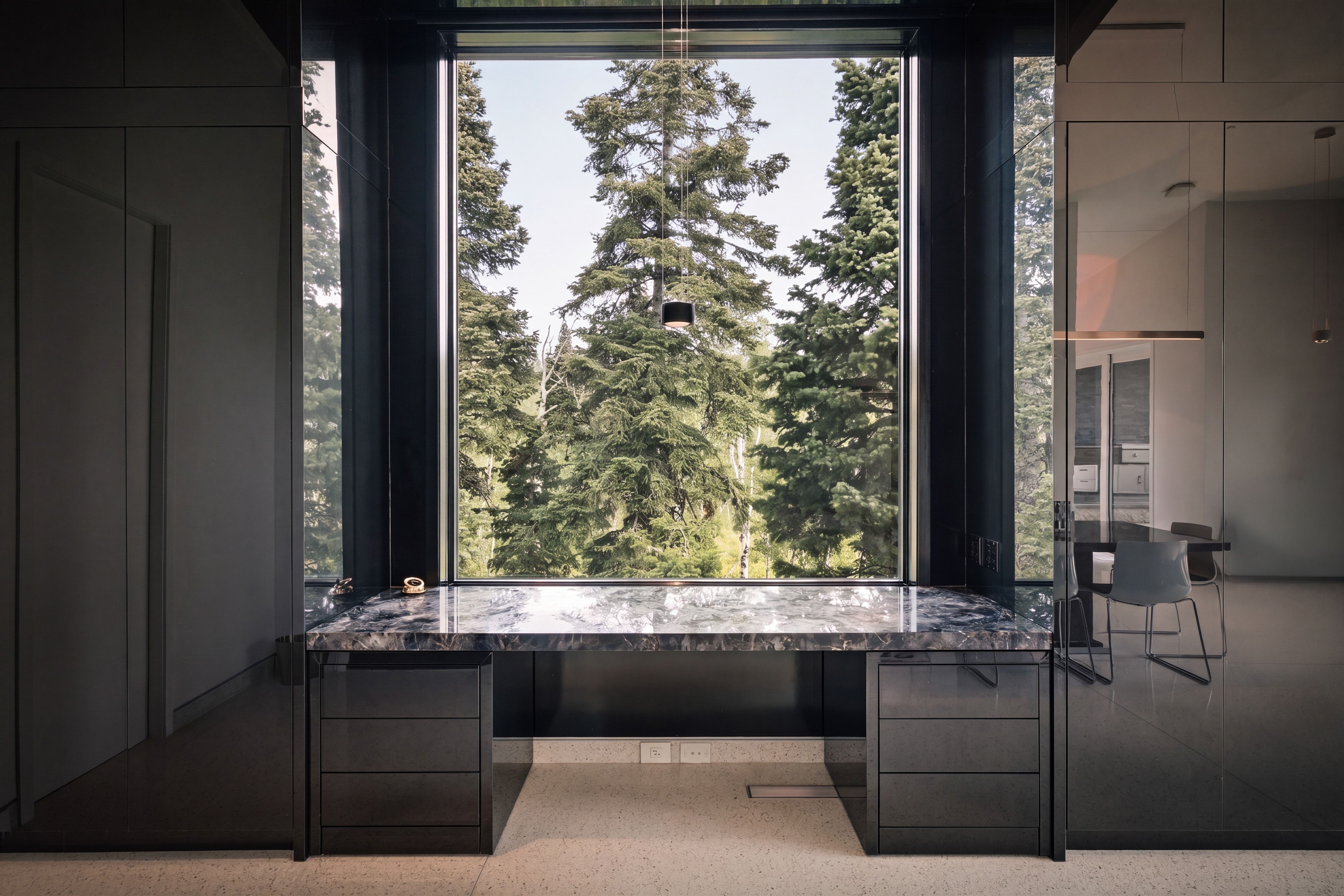 Floor-to-ceiling window framing mature trees