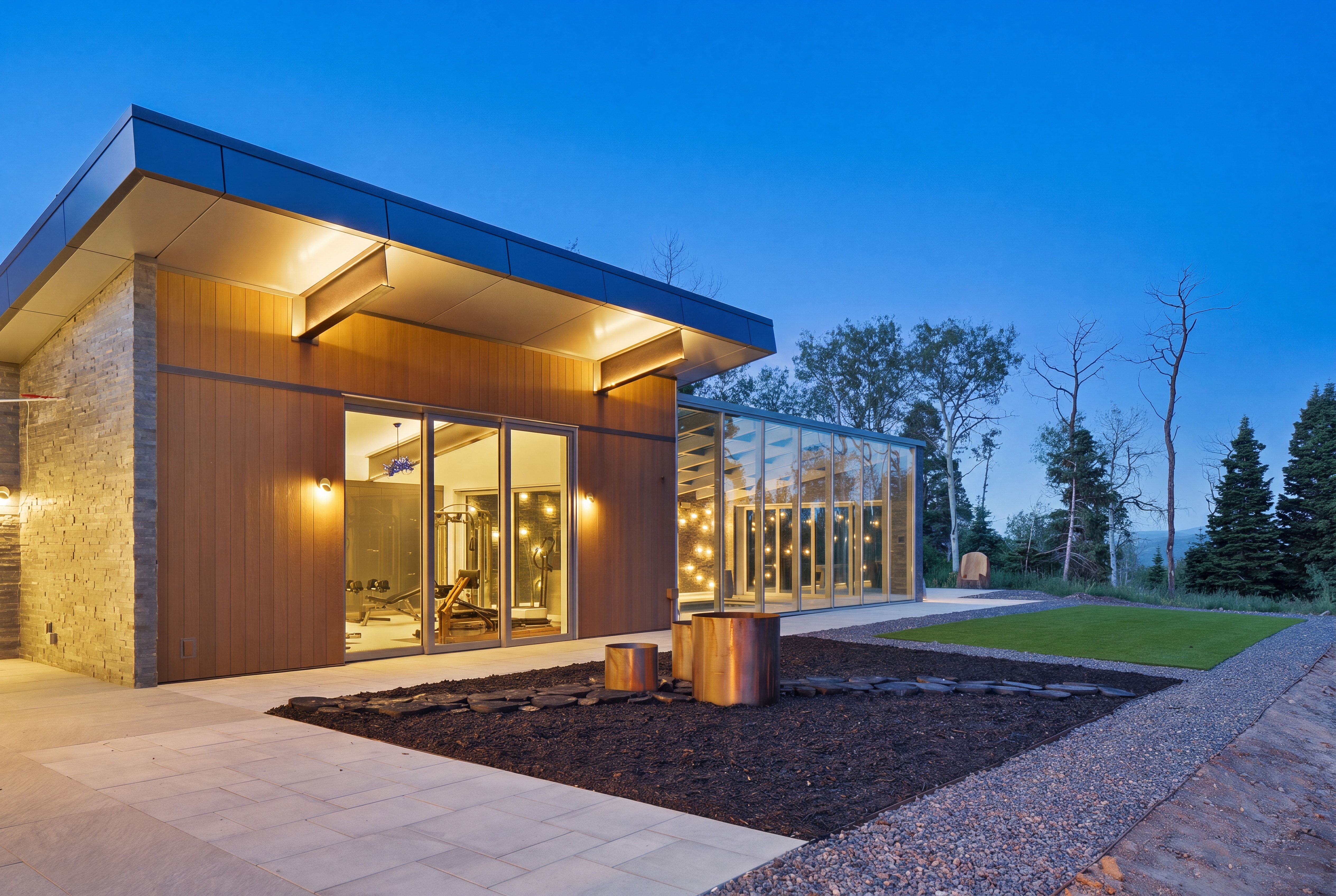 Modern building exterior featuring wood-look siding and stone accents