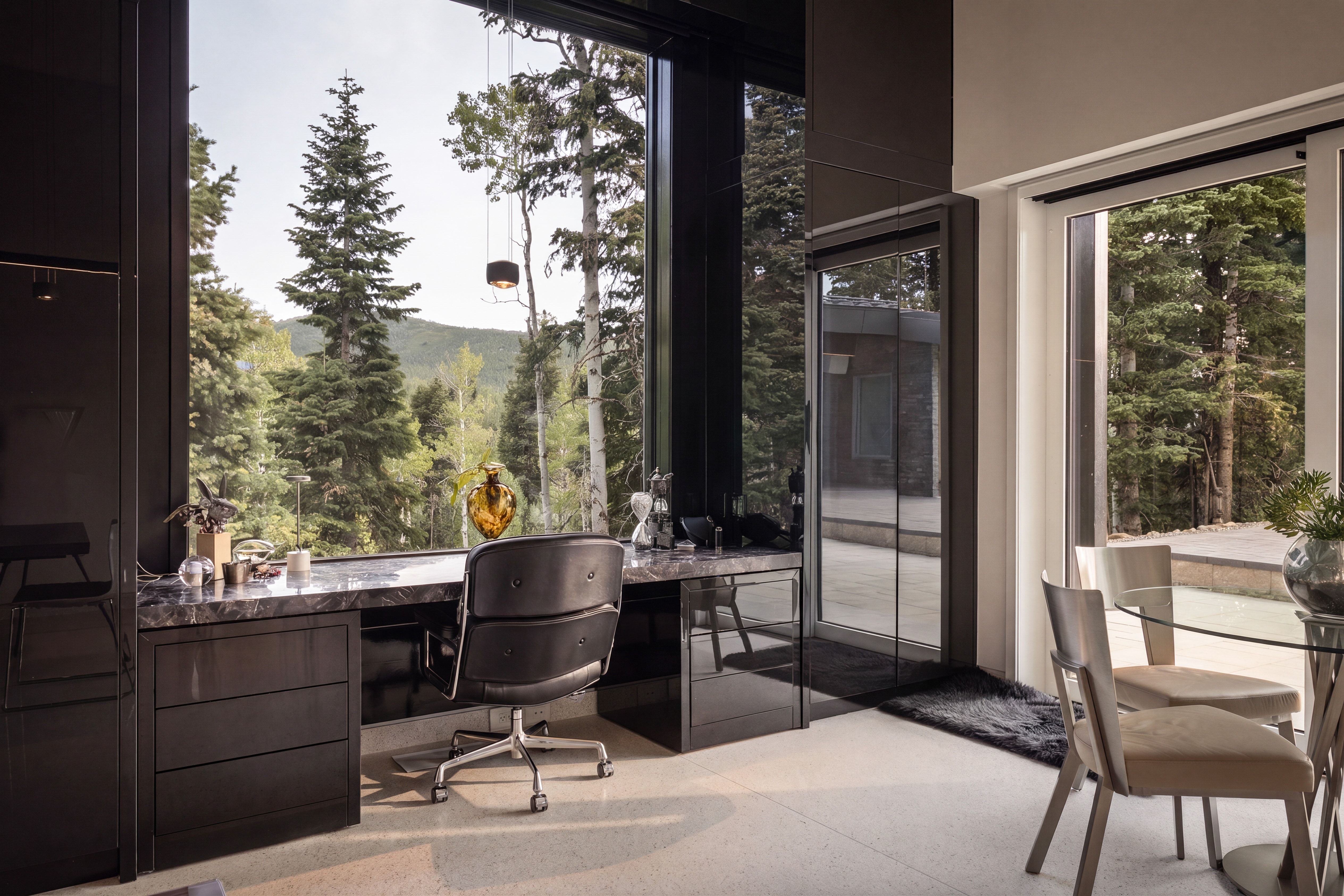 Floor-to-ceiling windows overlooking a natural landscape