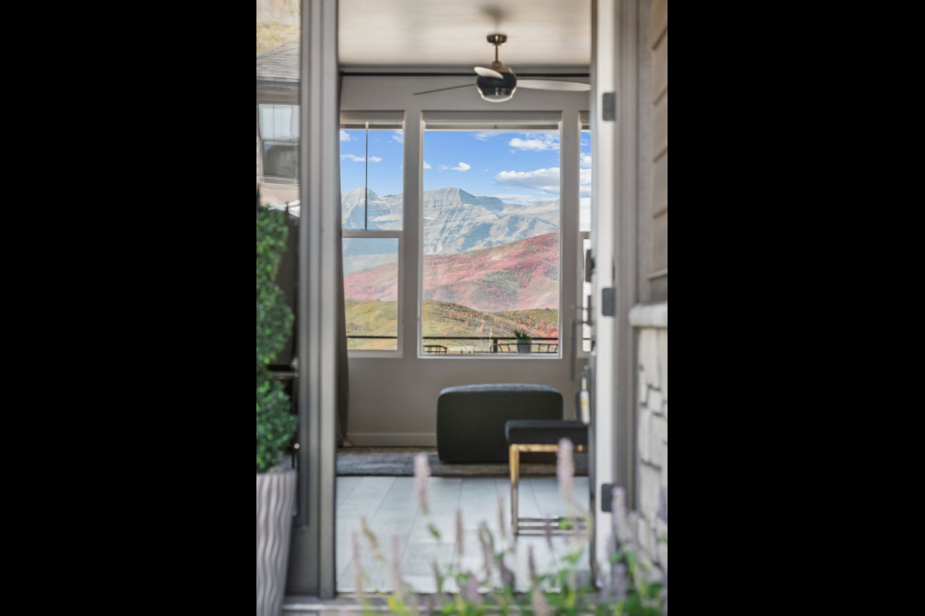 Terrace entry with a single panel door opening to a mountain panorama