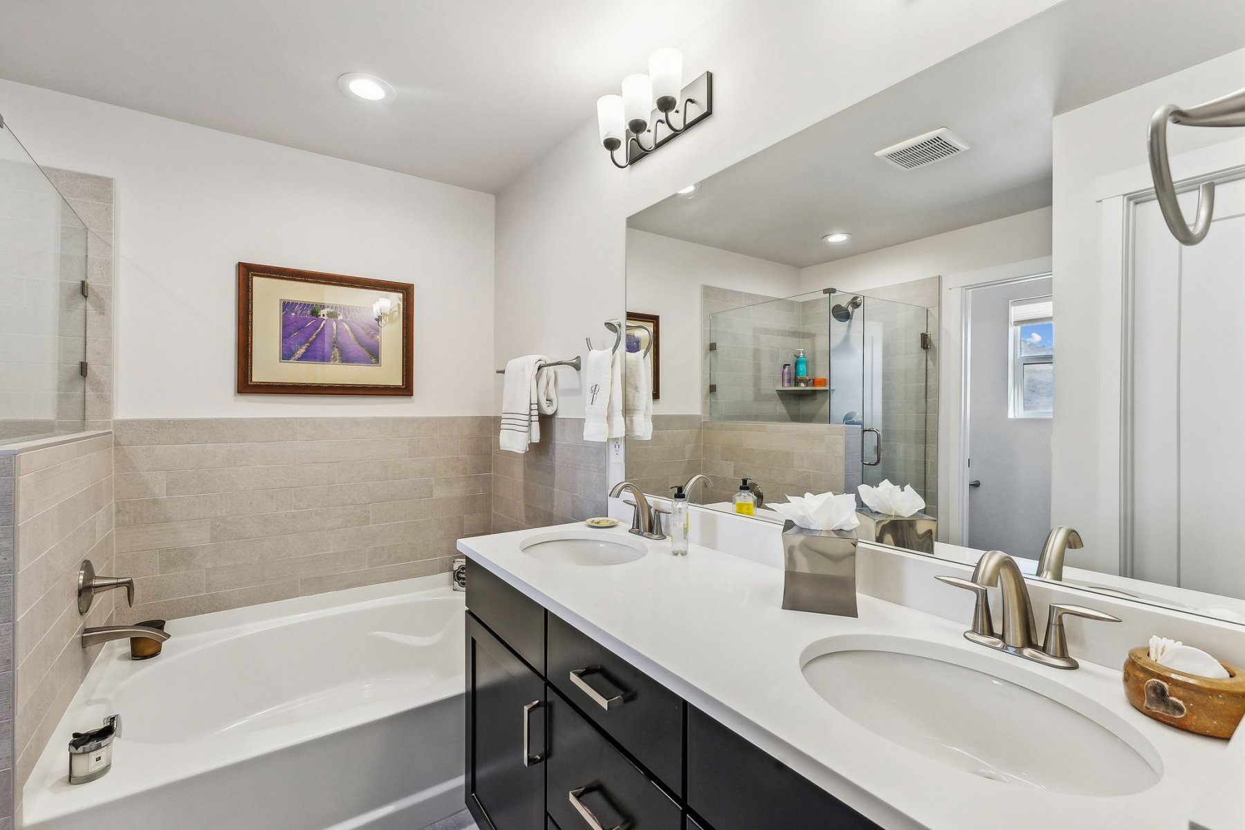 Double vanity with undermount sinks and dark cabinetry