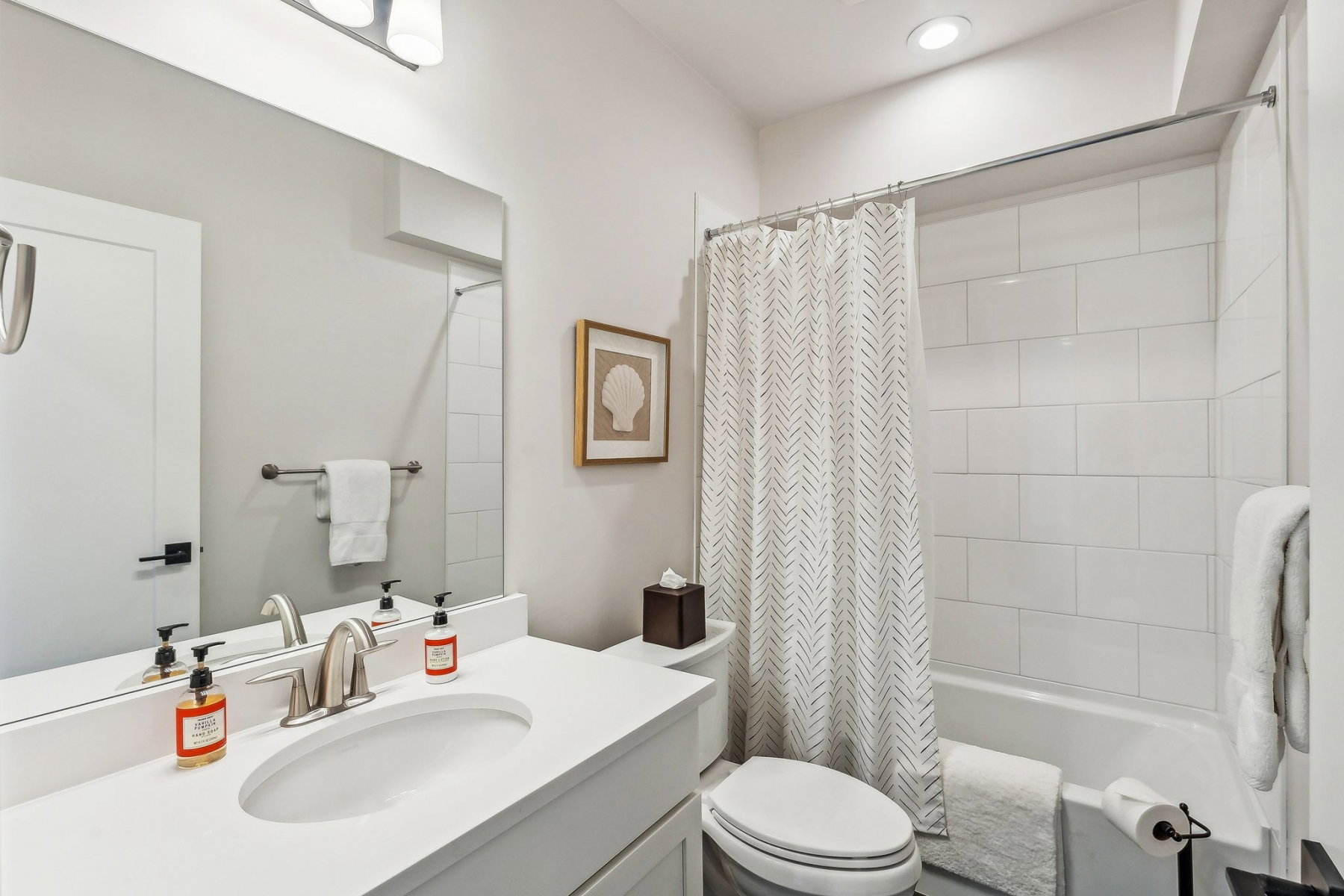Bathroom vanity featuring a single basin sink and a stone-finish countertop