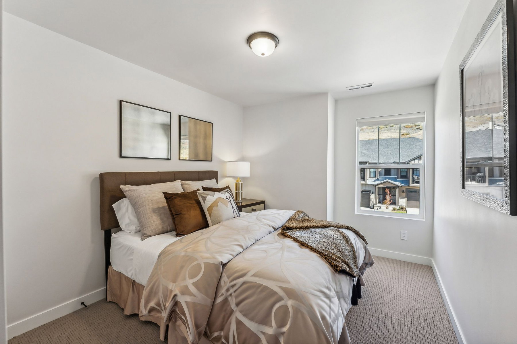 Bright bedroom featuring a single window, recessed lighting, and neutral-toned carpeting