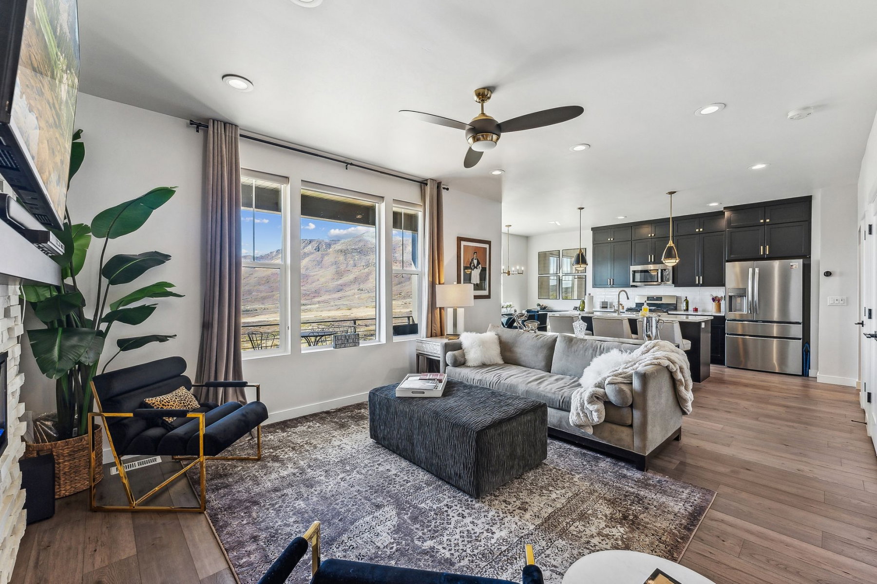 Open-concept living space featuring wood-finish flooring, recessed lighting, and a ceiling fan