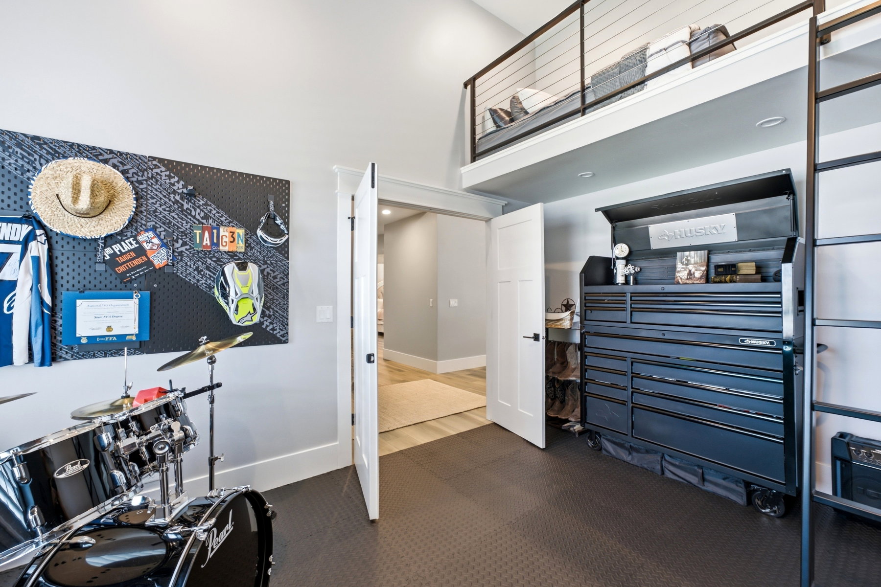 Room featuring a loft sleeping area with cable railing, high ceilings, and recessed lighting
