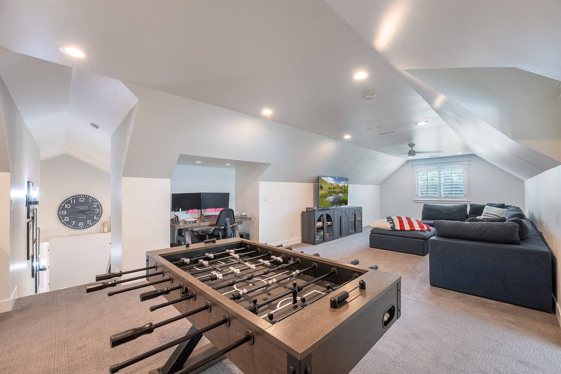 Attic space featuring sloped ceilings, recessed lighting, and carpeting throughout