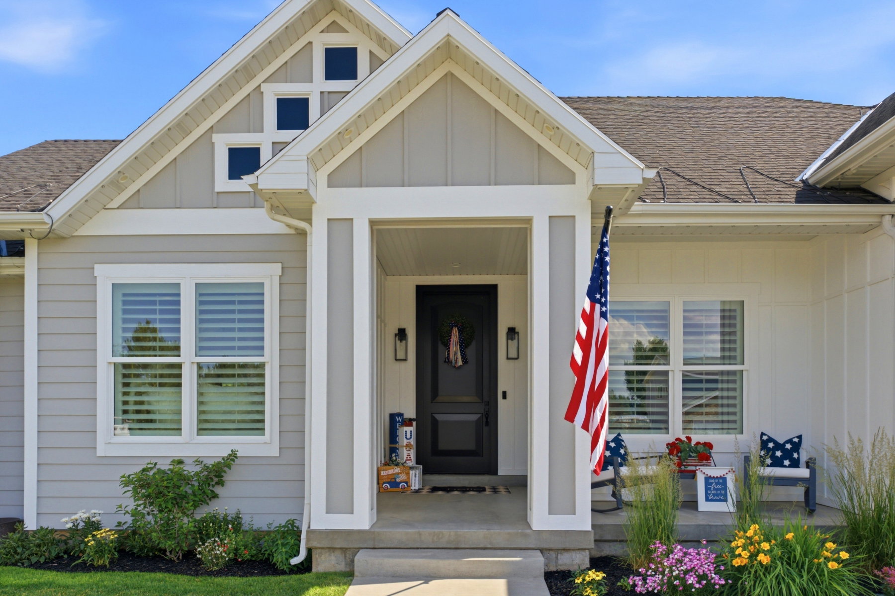 Modern farmhouse exterior featuring gray horizontal siding and white board and batten accents